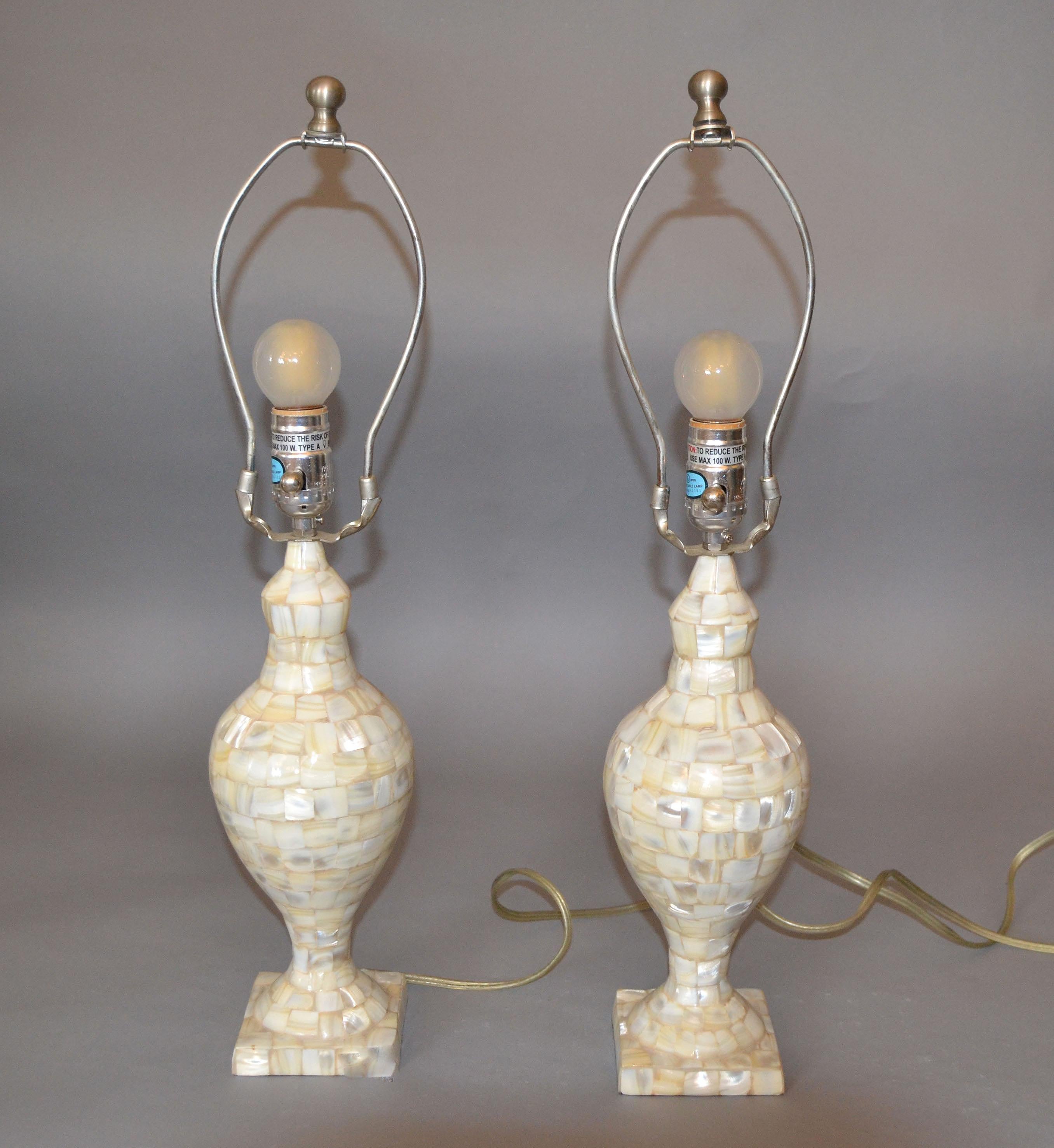 A pair of vintage Capiz shell table lamps.
Perfect working condition and each uses a max. 60 watts light bulb.
The set comes with harp, finial and original shades.
The original Shades are in need of replacement. 
Measurement shade:
Height 9 inches,