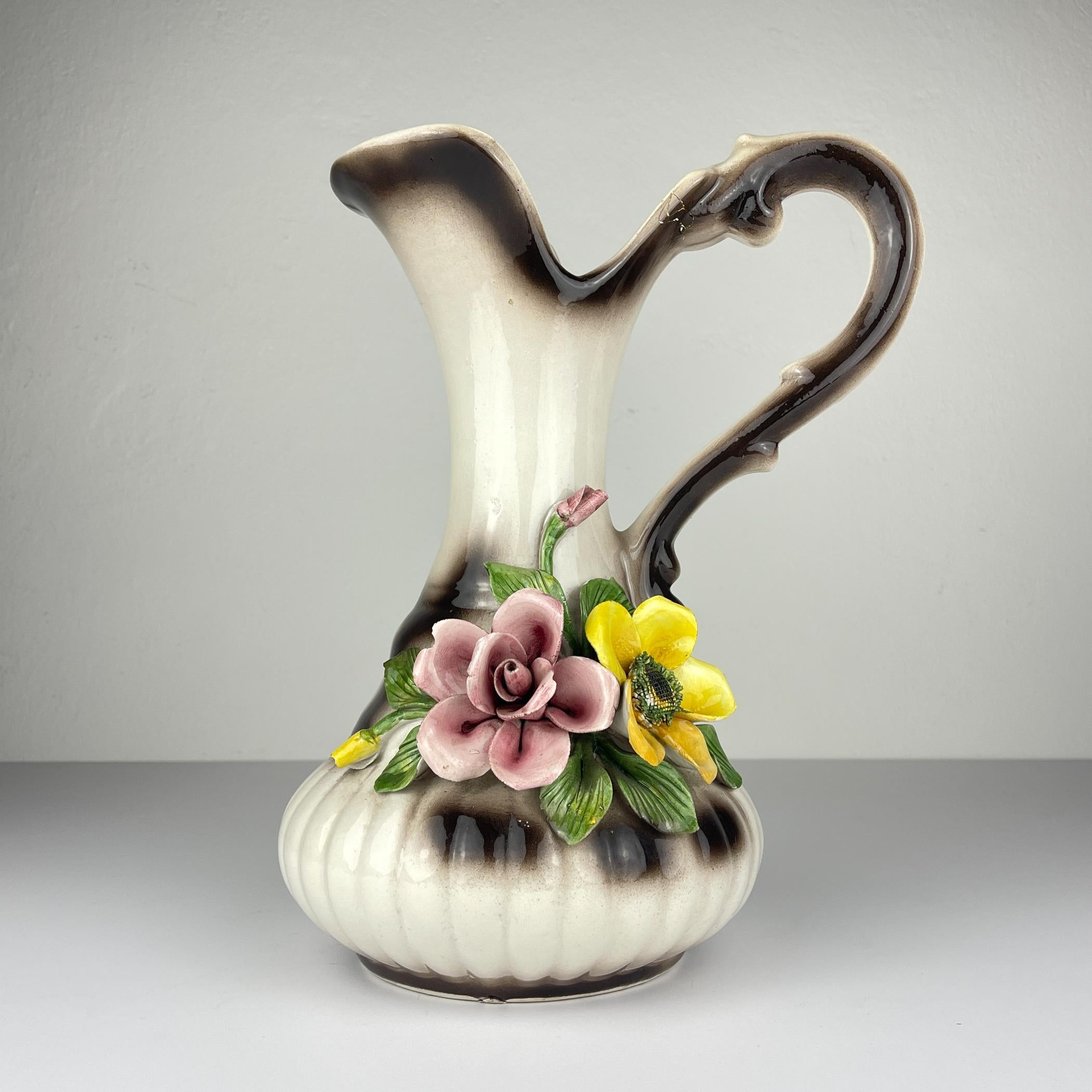 Large elegant porcelain jug with the Capodimonte stamp — the letter N under the crown. The rich relief decor, made by hand, is typical of the Italian Capodimonte tradition. It is ideal as a decorative element in an interior or for a collection.

The