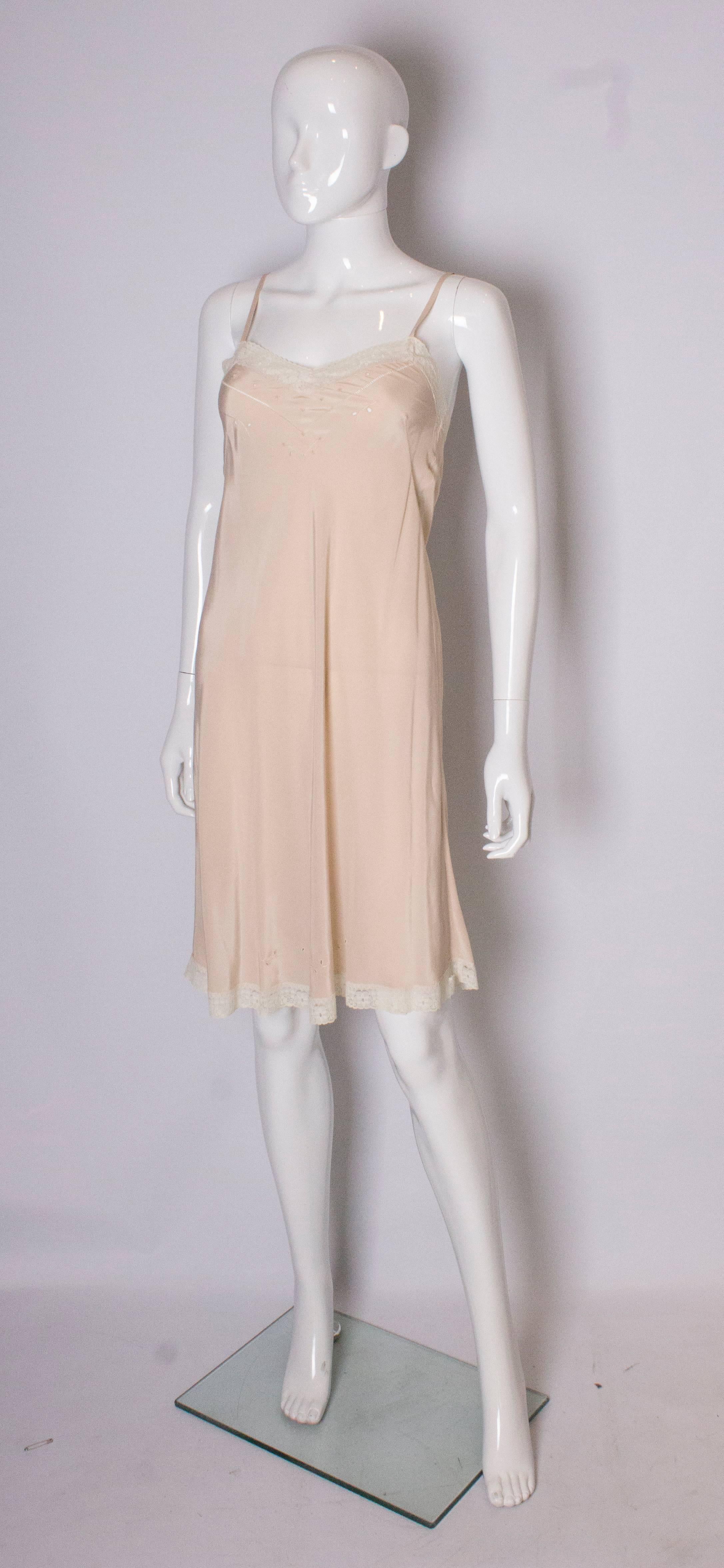 A lovely vintage slip in a heavy silk, in a caramel colour with lace trim and stitch detail.