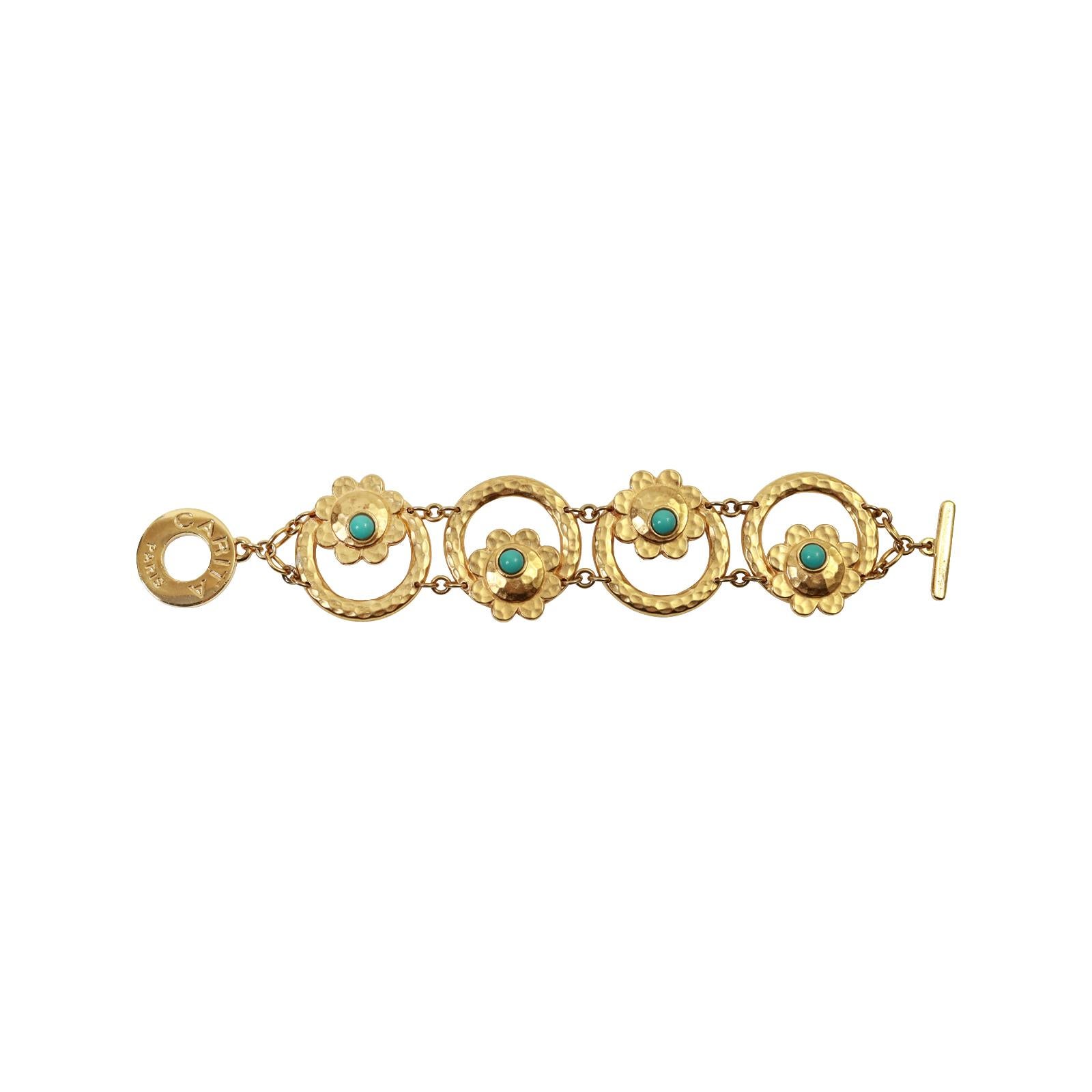 Vintage Carita Paris Gold Tone Bracelet Circa 1980s.  This is such a beautiful and well made bracelet.  There are round links that are hammered and inside are flowers with a disc of Faux Turquoise peeping out to make the flower. That sits on