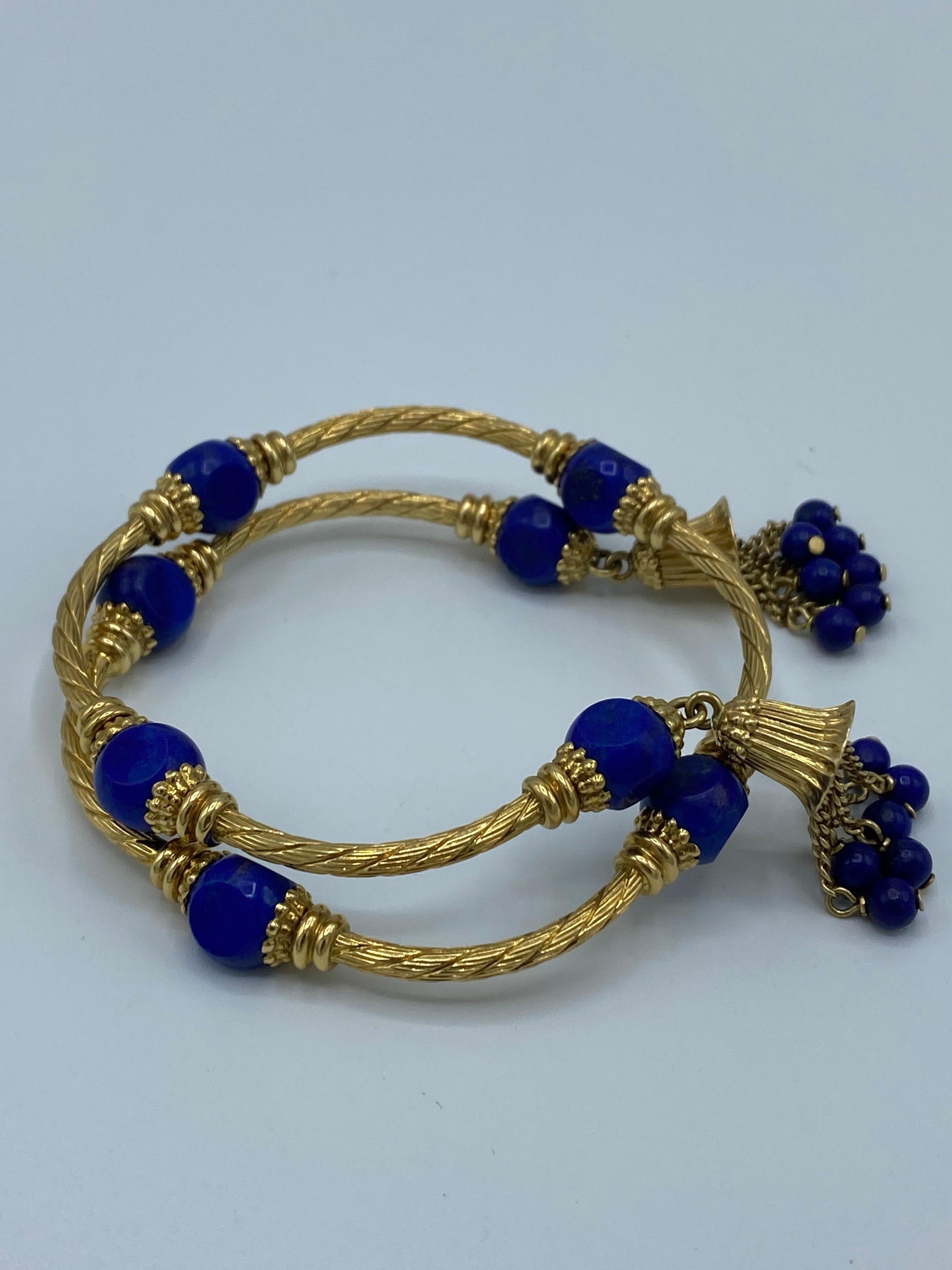 Product details:

The bracelet is designed by Carlo Weingrill, it is made out of 18 karat yellow wired gold and lapis beaded detail with gold chain and lapis beads tassel on each end of the bangle, the bracelet features wrap around
