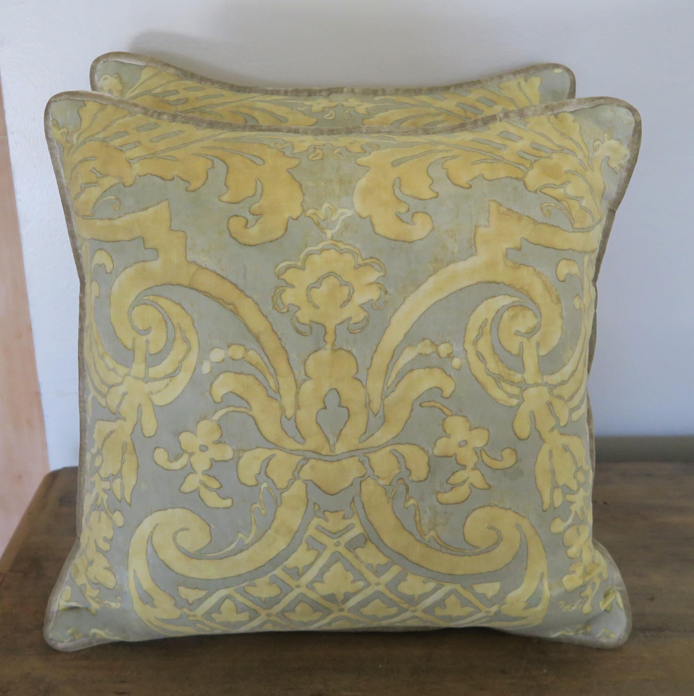 A pair of custom Carnavalet patterned Fortuny pillows made from vintage faded gold and taupe colored cotton Fortuny fronts and silvery velvet backs. Self cord detail, down inserts, sewn closed.