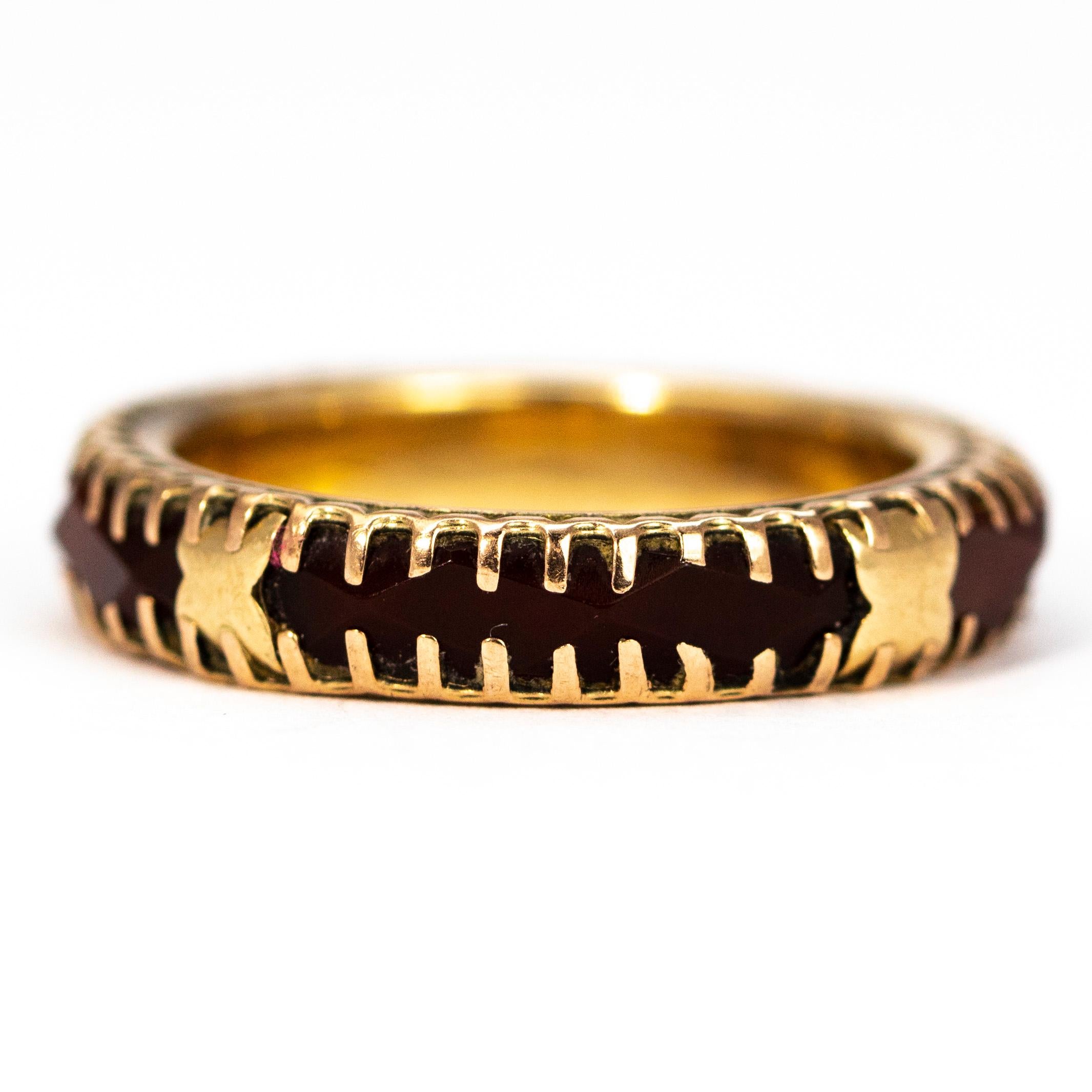 This wonderfully unusual eternity band is chunky and has so much detail. The carnelian stone carries all the way around this band and every now and then has a gold cross shape set over the top. The stones are held in place with prominent gold teeth