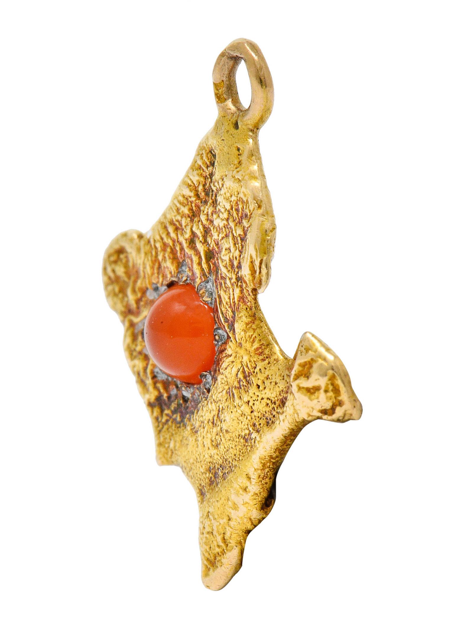 Charm is designed as the country of France with Paris accented with a 3.5 mm cabochon

Carnelian is graver set and features translucent orangey-red color

Tested as 18 karat gold

Circa: 1960s

Measures: 5/8 x 3/4 inch

Total weight: 2.0