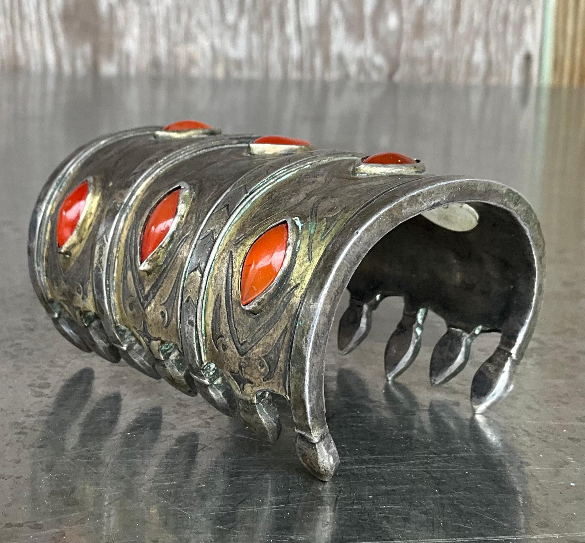 This vintage Turkoman cuff bracelet is a stunning example of traditional Central Asian jewelry, featuring rich cultural symbolism and expert craftsmanship. Handcrafted from gilt silver—a silver alloy washed in gold—the piece is adorned with polished