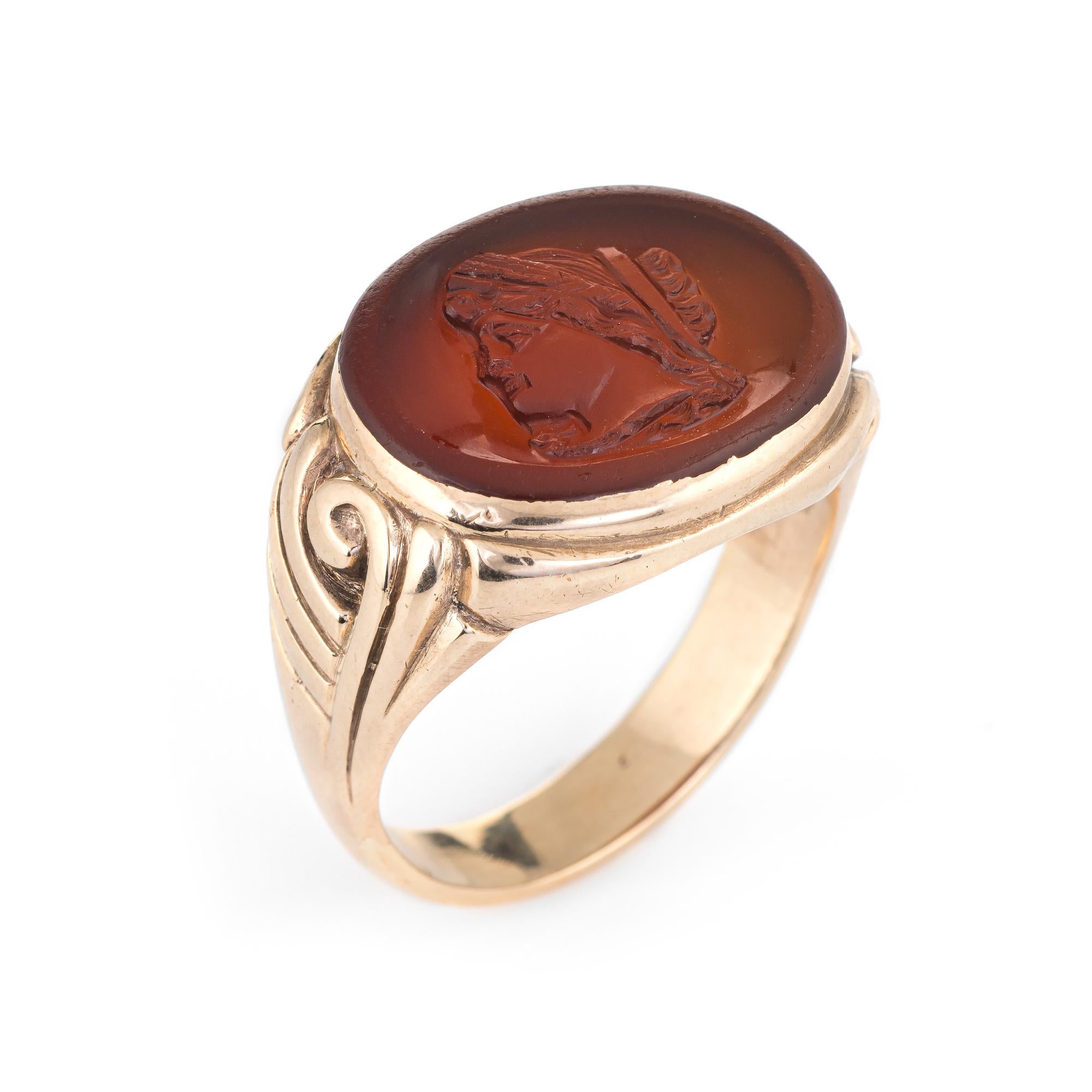 Finely detailed carnelian intaglio ring (circa 1940s to 1950s) crafted in 14 karat yellow gold. 

Carnelian measures 20mm x 16mm. The carnelian is in excellent condition and free of cracks or chips. 

The carnelian is set in an east-west profile. A