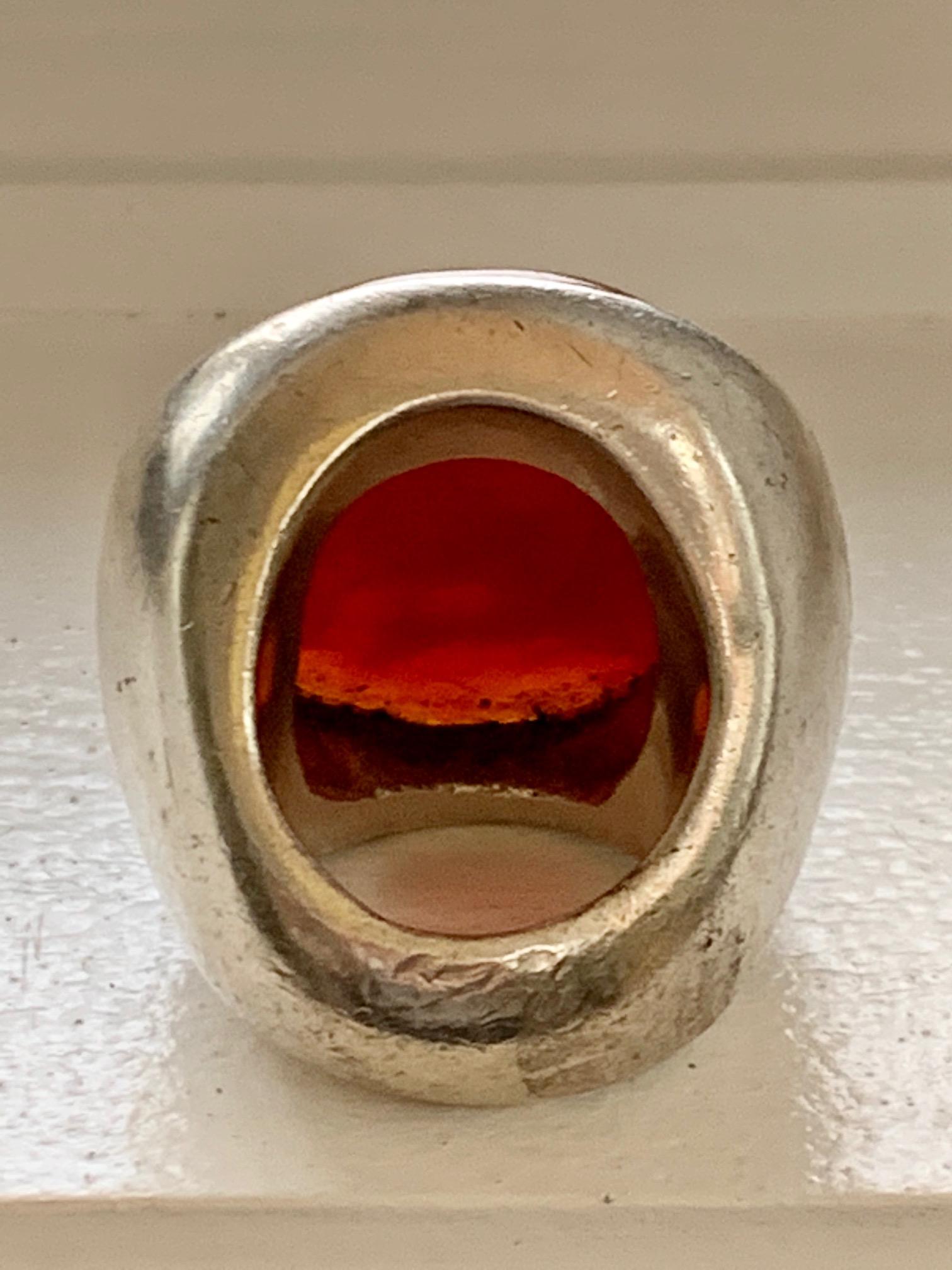 This gorgeous ring features one large, 35 x 28mm Carnelian cabochon stone.  It is set in a sterling Silver setting, which is stamped 