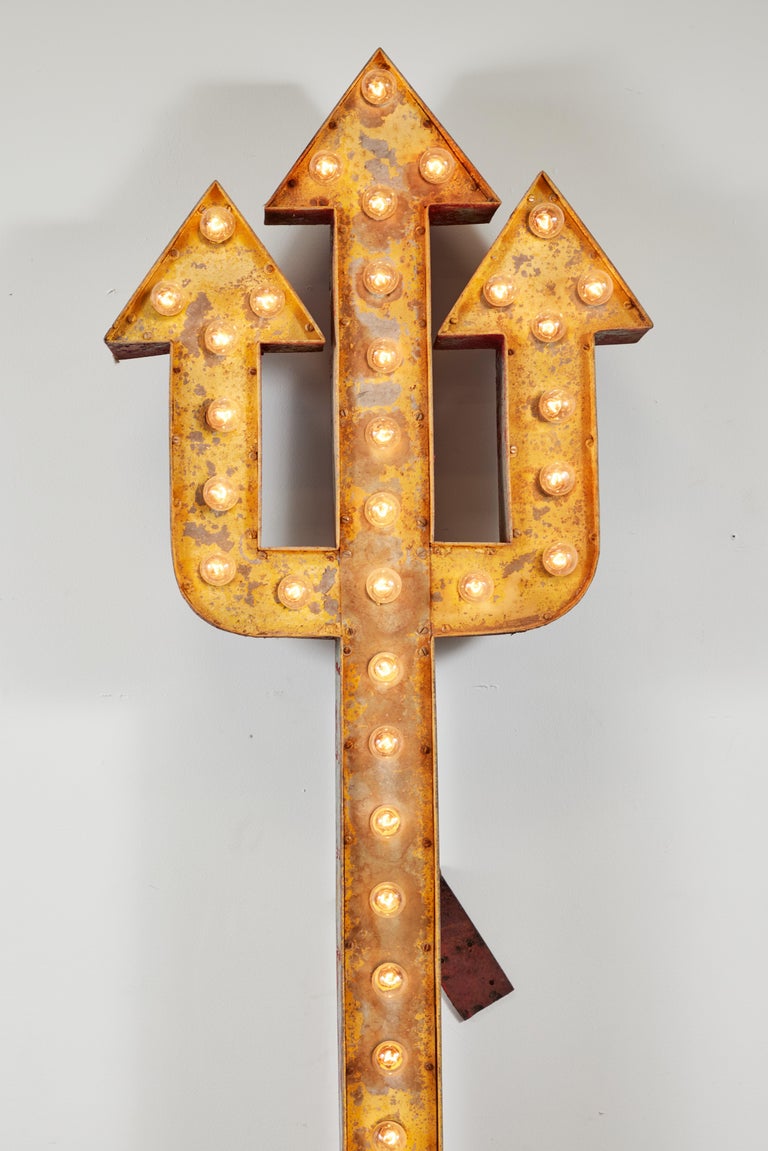 Unique lighted Neptune's trident carnival ride or casino trade sign. Really nice graphic piece. Original layers of golden yellow and red park paint. Provides a nice amount of warm light.