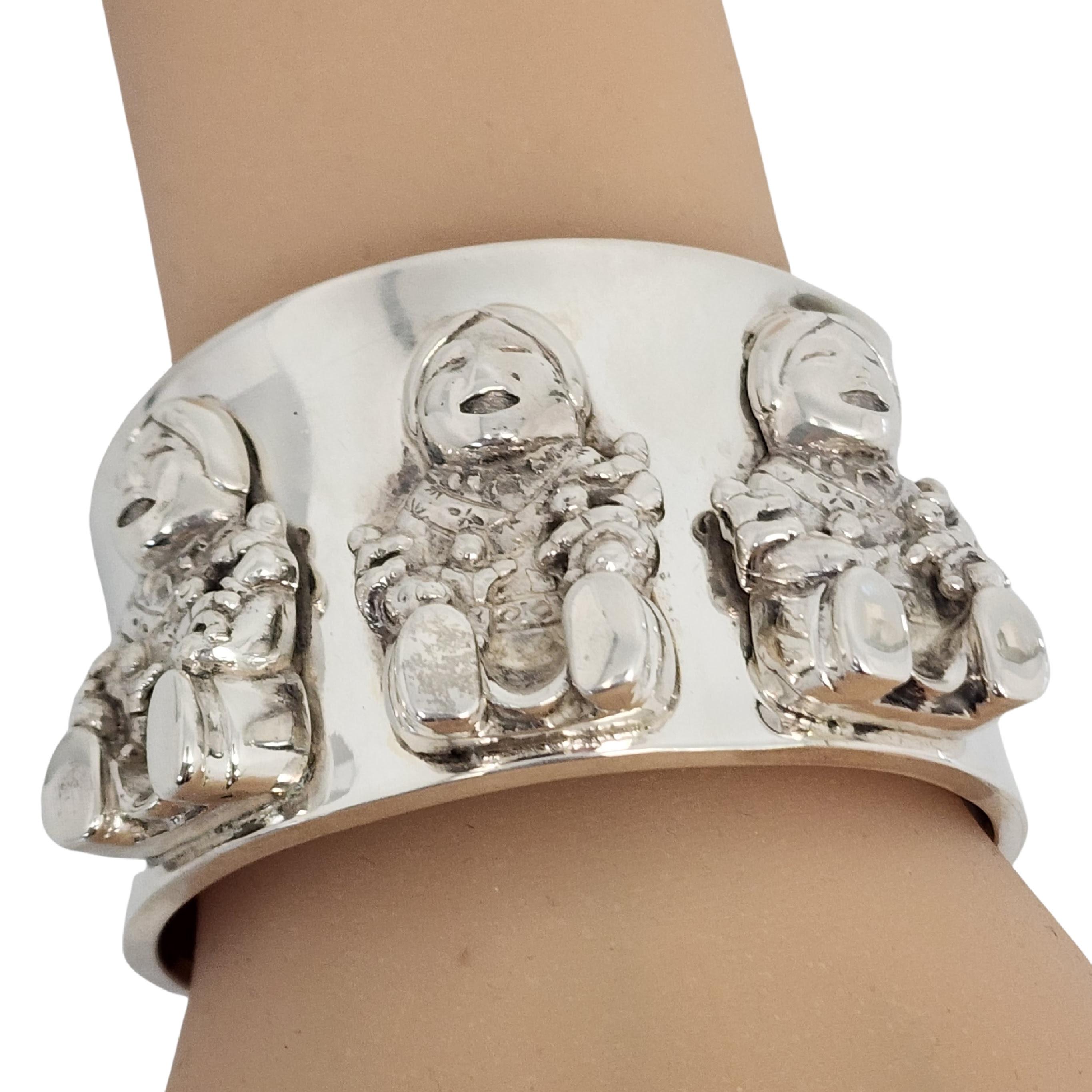 Sterling silver storyteller cuff bracelet by Carol Felley.

Beautiful storyteller bracelet inspired by Pueblo pottery featuring 3 large applied mothers and their children singing songs of tribal stories.

Measures approx 6