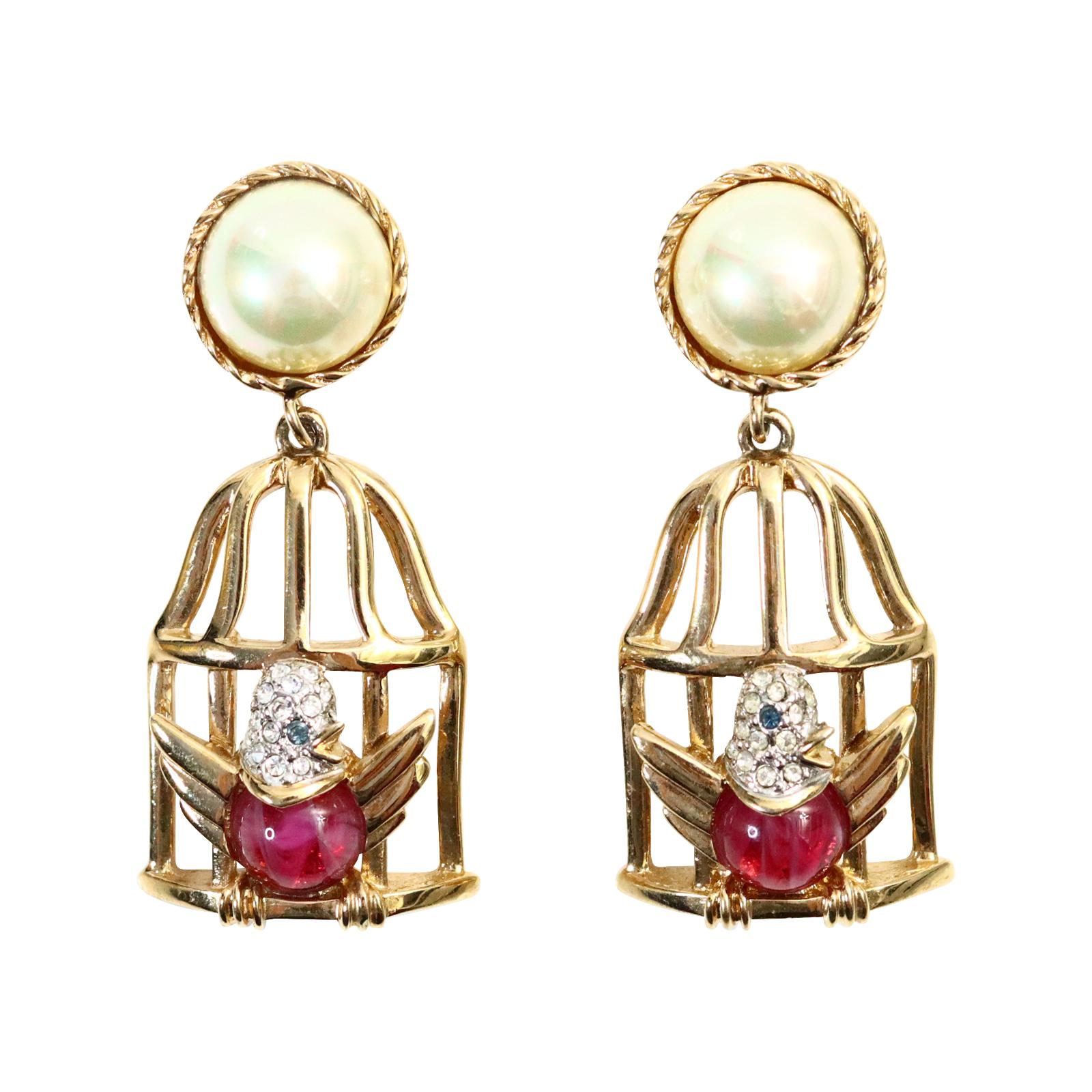 Vintage Carolee Gold and Faux Pearl Dangling Birdcage Earrings Circa 1980s. The earrings have a gold bird with a pink cabochon and diamante face in the gold cage. So stylish. 
Yes, these are sweet but they are also very well made! Clip On.