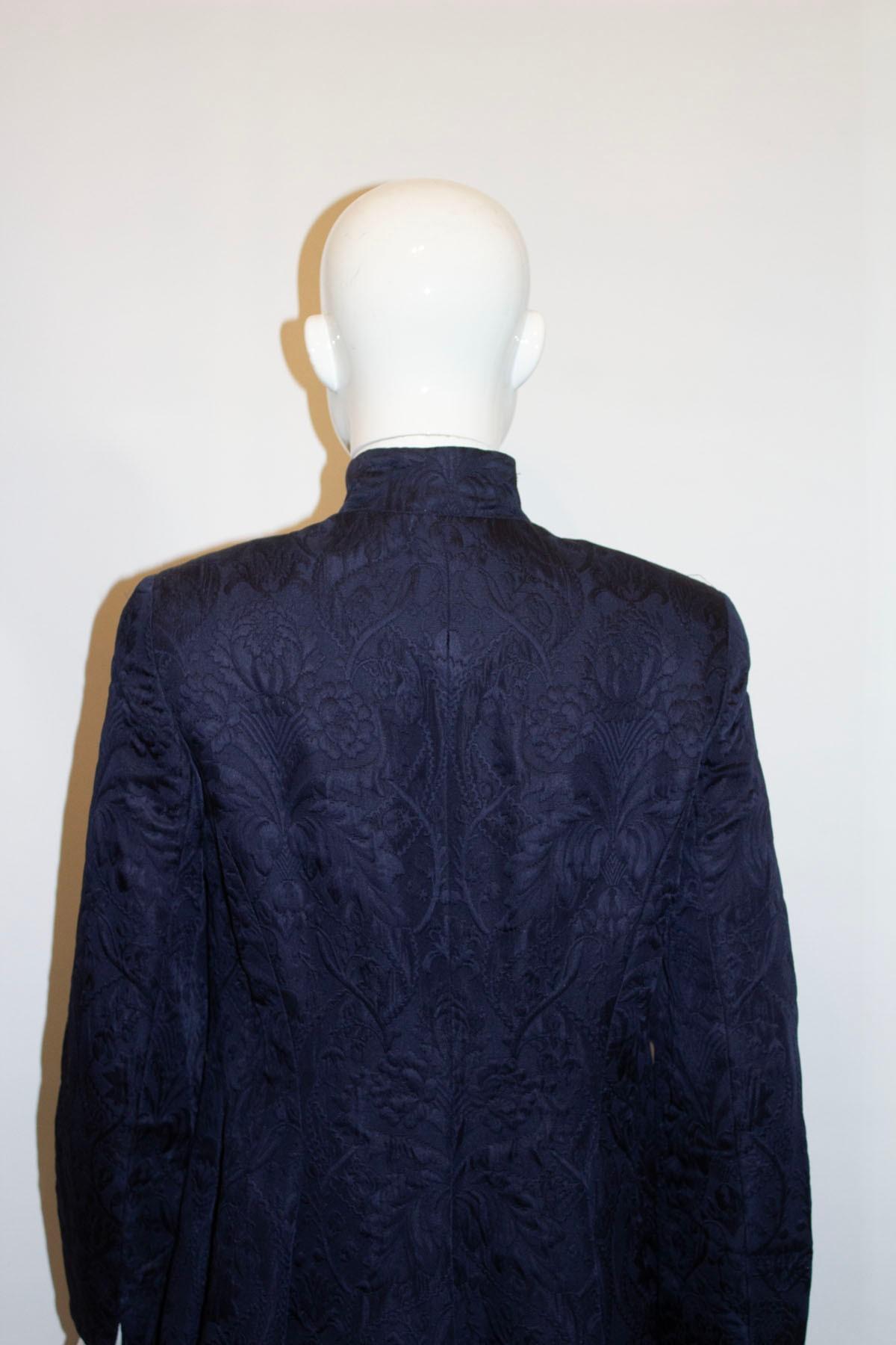 A chic, and easy to wear vintage evening jacket by Caroline Charles. In a dark navy colour , the jacket is in a wonderful textures silk /wool mix. It has a stand up collar, front button opening  and flared hem.  The jacket is fully lined.