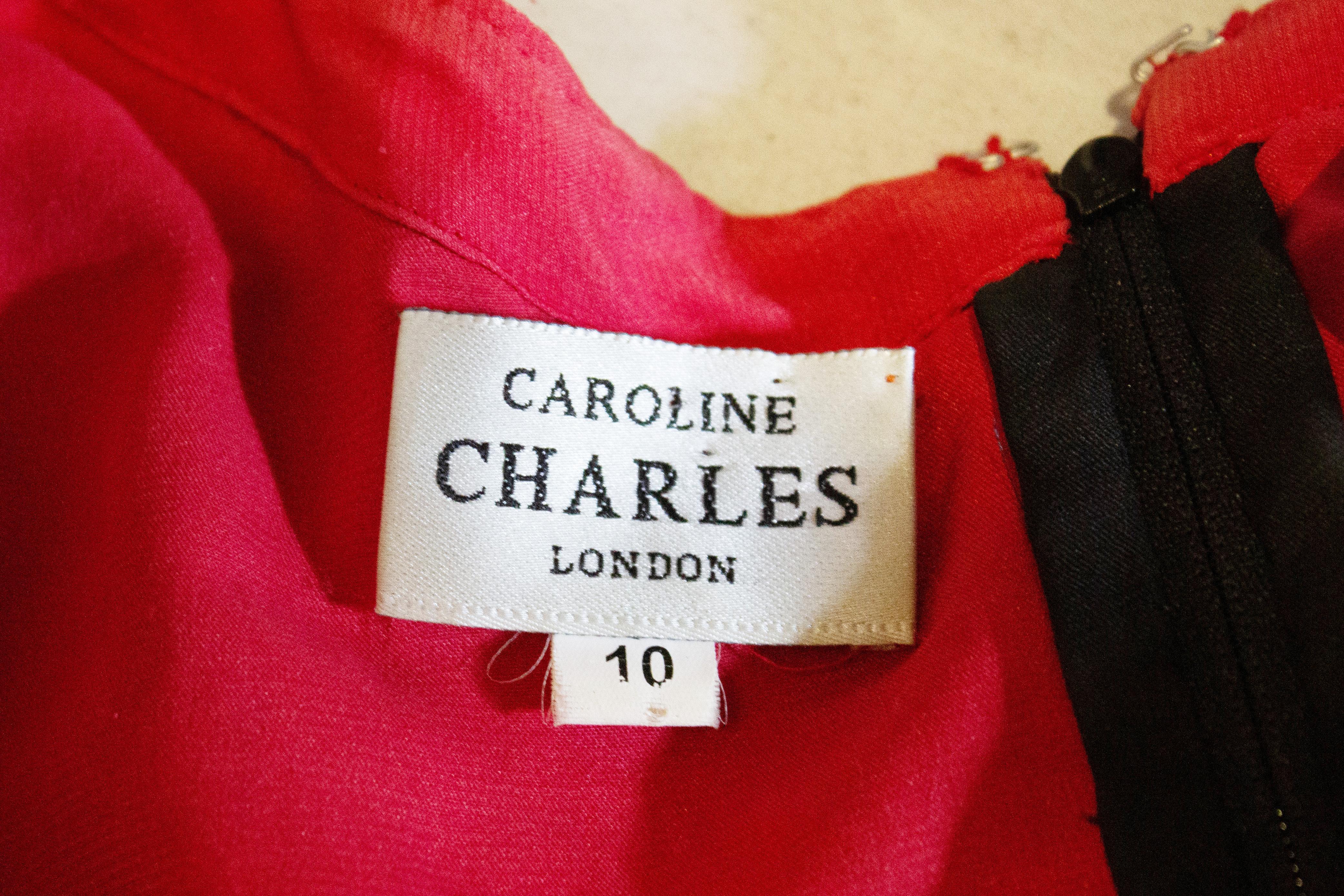 A stunning vintage evening top by Caroline Charles. The outer layer is in black lace with sequin and bead detail, and the lining layer is black and red. It has a sweetheart neckline and a v backline. with a zip opening and scalloped hem.