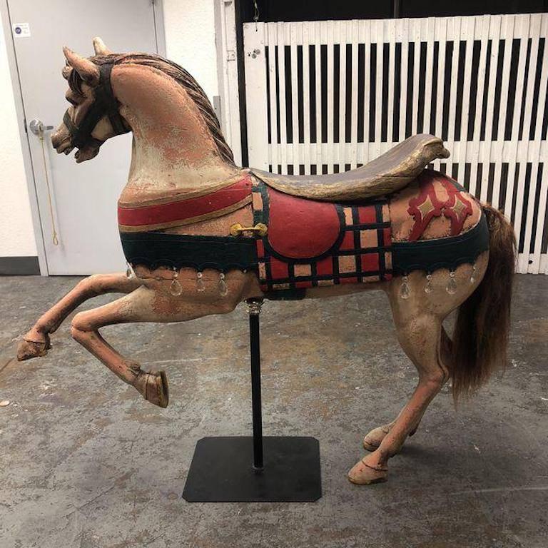 A unique treasure or gift. This vintage carousel horse is constructed of fiberglass and painstakingly painted to delight one and all. Accented with glass crystals and placed on a iron stand.
 