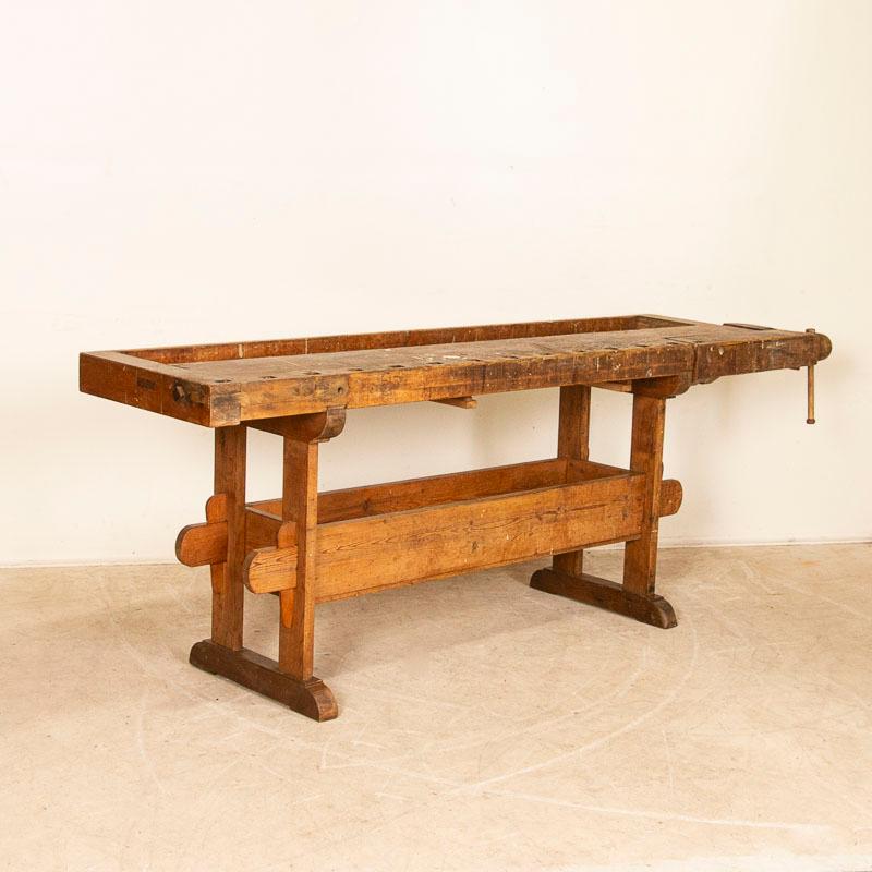 The patina of this authentic carpenter's workbench is a reflection of its age and years of use. Every ding, scratch, gouge, paint spill and stain enrich the character and appeal of this old work table. Please examine the close up photos to