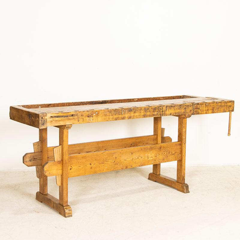 This rustic carpenters’ workbench reveals a dark patina after years of traditional use. Please examine the close up photos to appreciate the depth of the patina and notice the dings, scrapes, gouges and even residual old paint that reflect how it