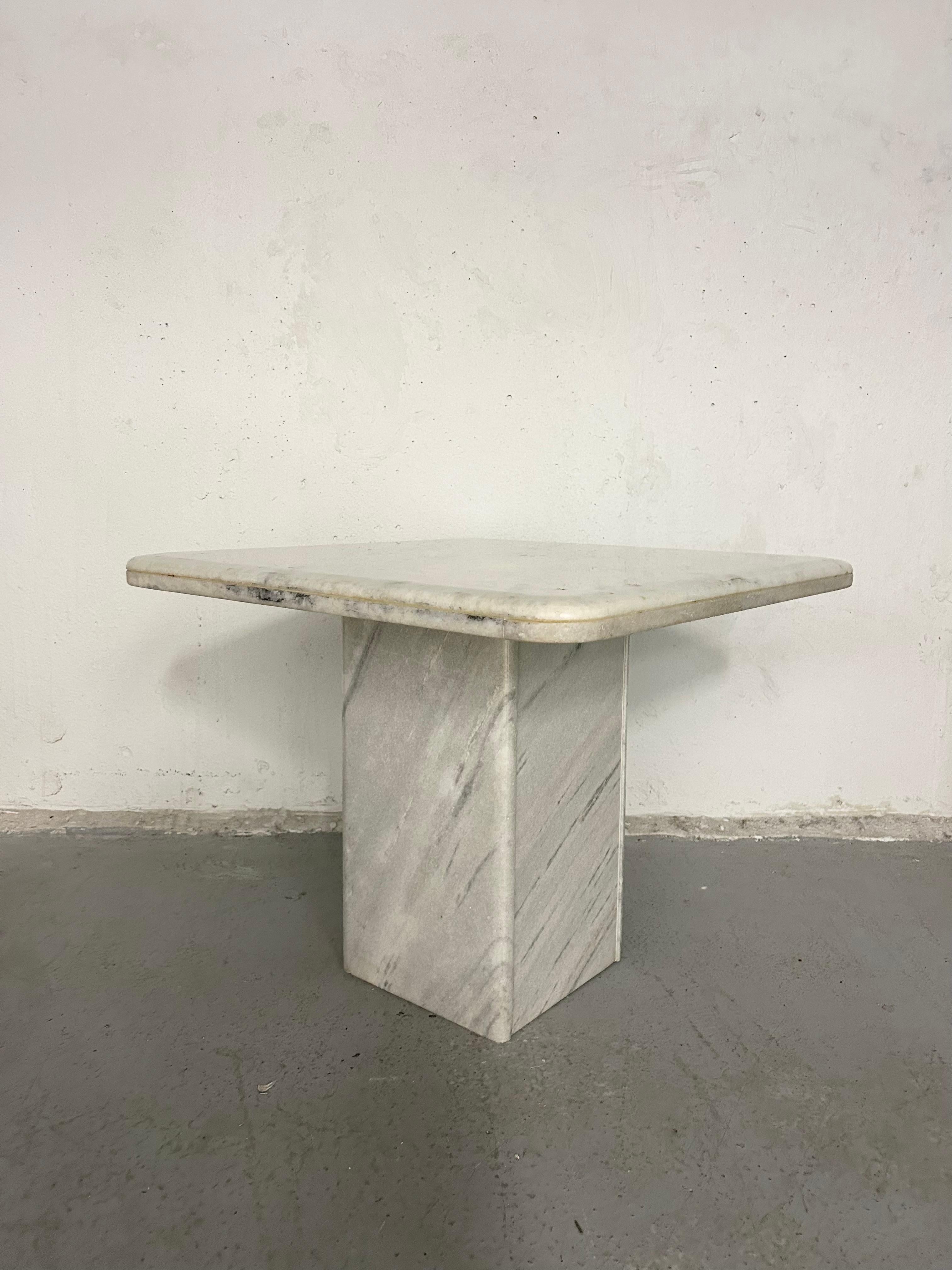 Vintage Carrara marble side table. Could also be used as coffee table or nightstand. No chips or cracks in the marble. Normal vintage wear. There are a few small chips in the polyurethane sealant on the table top but are very subtle and not that