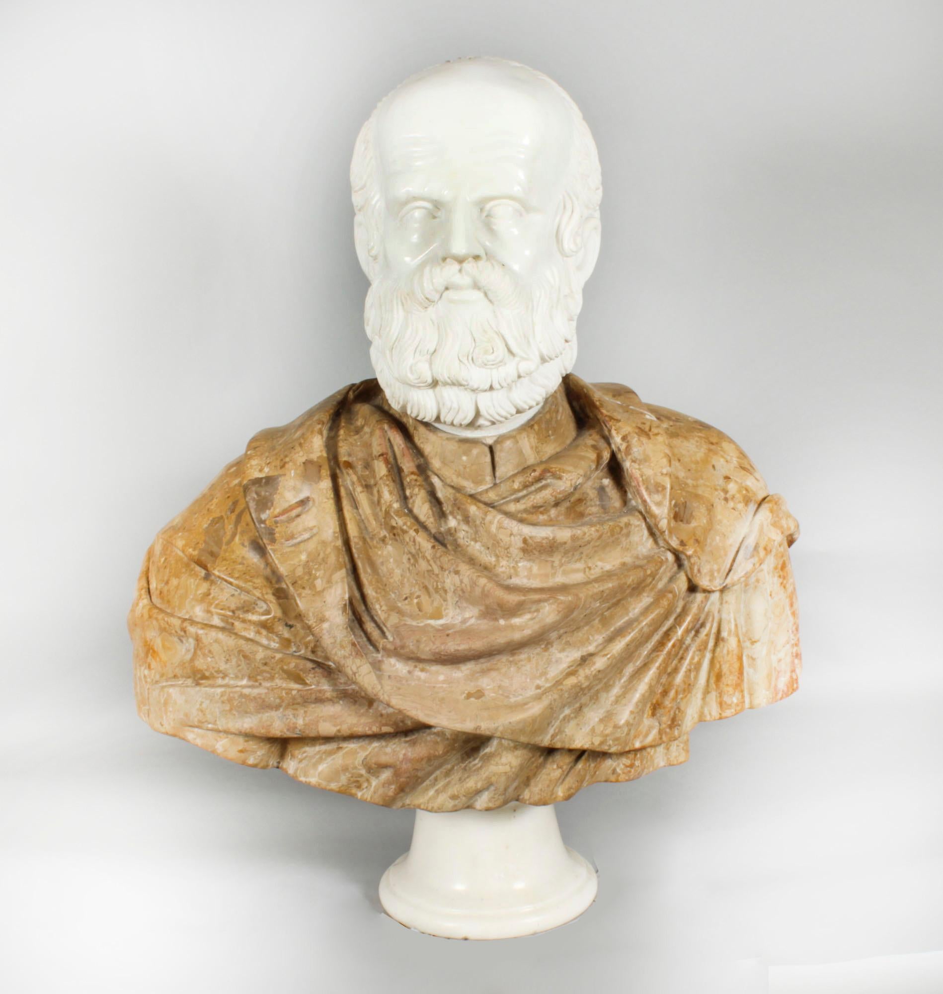 This is monumental vintage Italian marble shoulder length carved bust of Socrates, dating from circa 1950 in date.
 
His face and body has been sensitively modelled in Scagliola and Carrara marble on a cylindrical Carrara plinth base, the bust is
