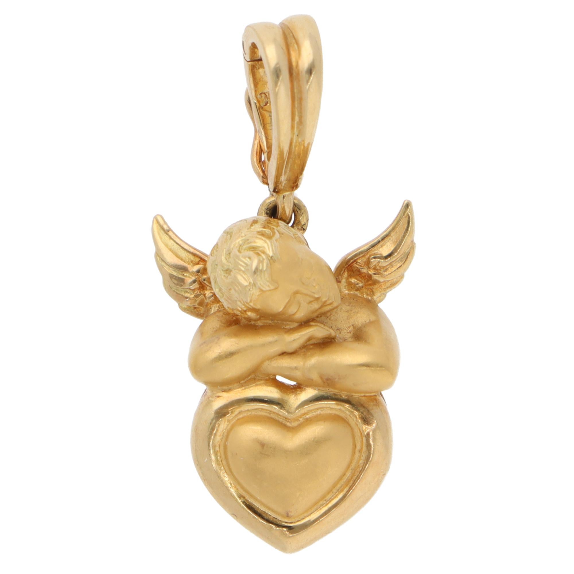 A beautiful vintage Carrera y Carrera My Angel heart pendant set in 18k yellow gold.

The pendant is composed of an iconic angel resting on a yellow-gold heart, with ridged gold detailing on the wings and heart. It is beautifully hand-crafted with