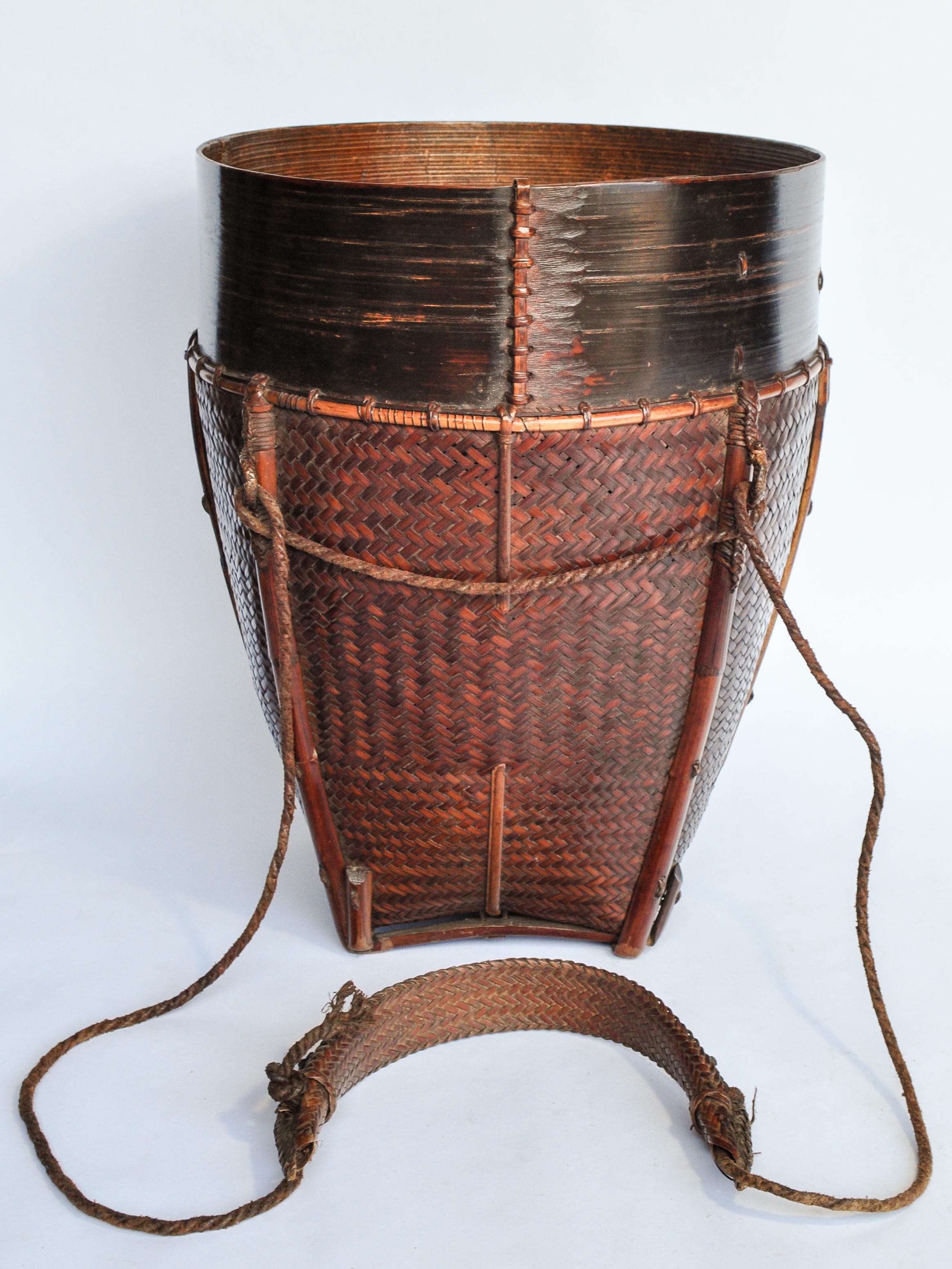 Vintage bamboo carrying and storage basket with strap, from the Rawang People of Burma, Mid-20th Century.
This cleanly woven utilitarian basket was used in a variety of tasks, to transport and store any number of items in the rounds of daily