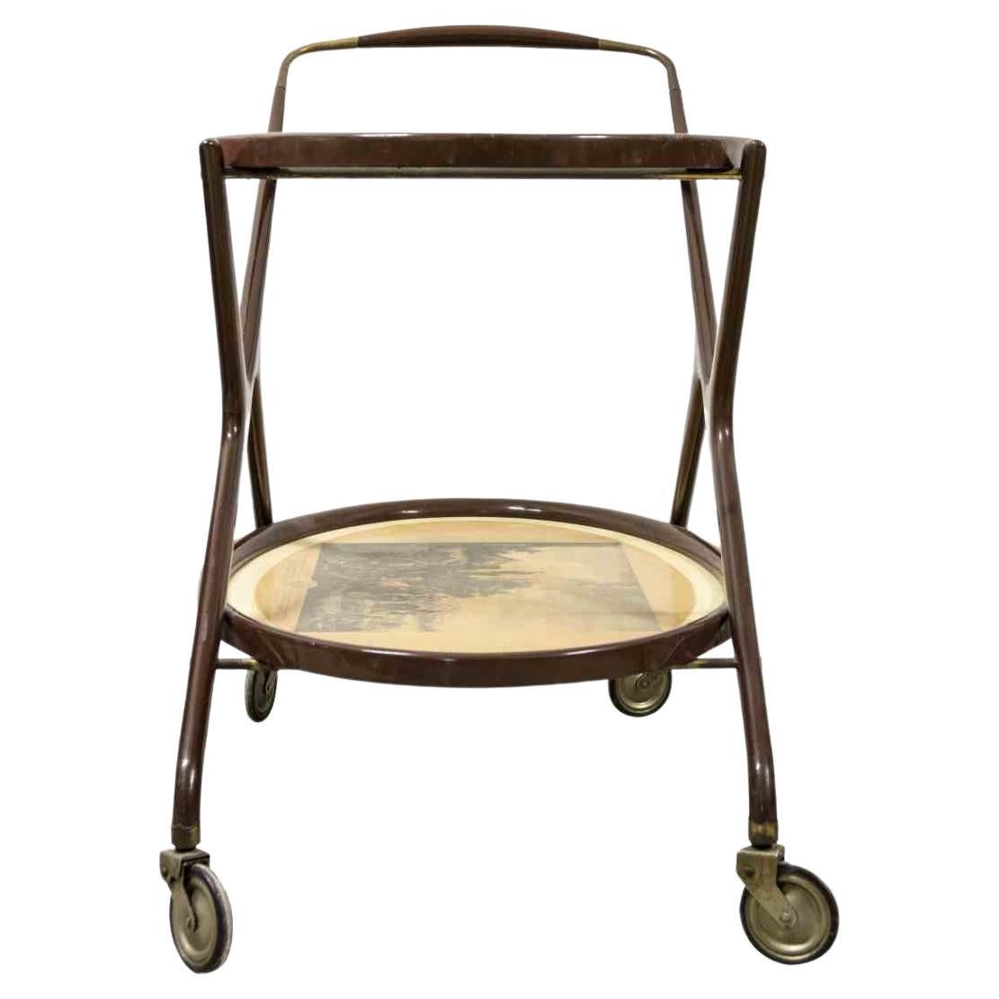 Vintage Cart is an original design item attributed to the Italian designer Cesare Lacca in the 1950s.

A wooden brass bar cart with shelves glass. The serving cart has a lithograph on the base. 

Rare and good conditions. 

Serve your drinks