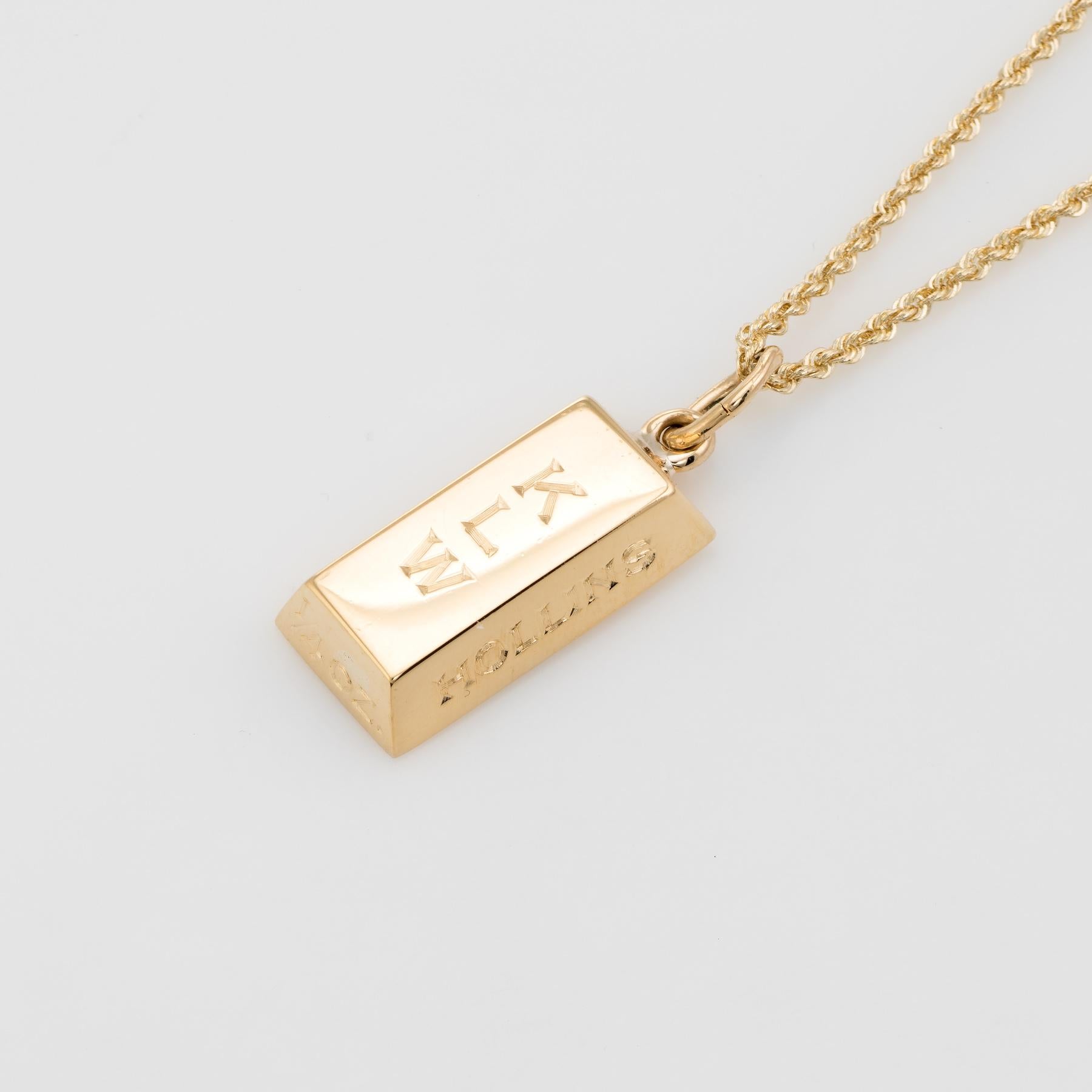 Stylish Cartier gold bar pendant or charm, crafted in 18 karat yellow gold. 

The solid three dimensional gold ingot can be worn as a pendant on a necklace or as a charm on a bracelet. The ingot is engraved 'KLW' and 'Hollins' along with the back of
