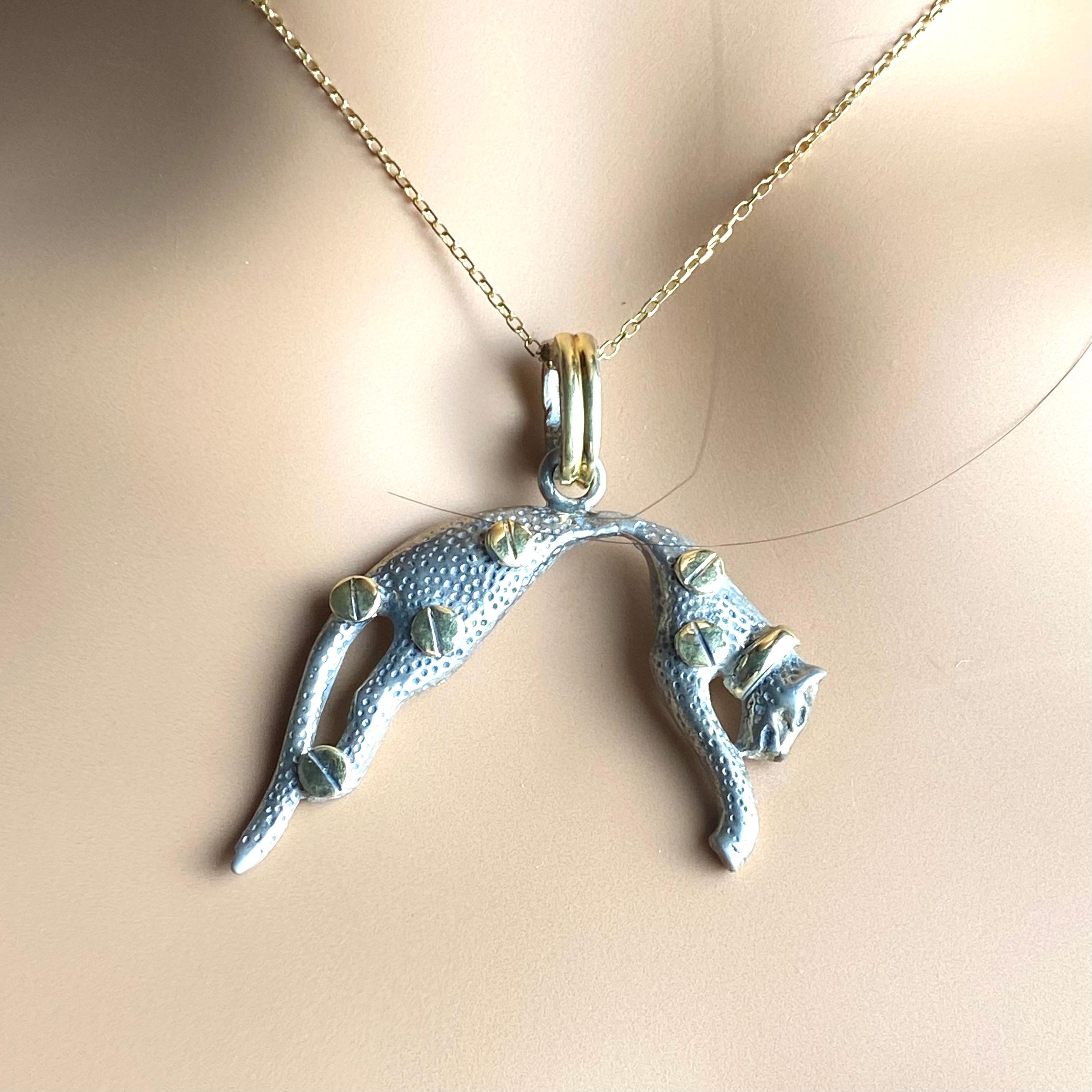 A Striking Blend of Iconic Design and Luxurious Craftsmanship
Elevate your jewelry collection with this vintage Cartier pendant necklace, combining 14K yellow gold and sterling silver in a captivating feline motif. Complete with Cartier’s signature