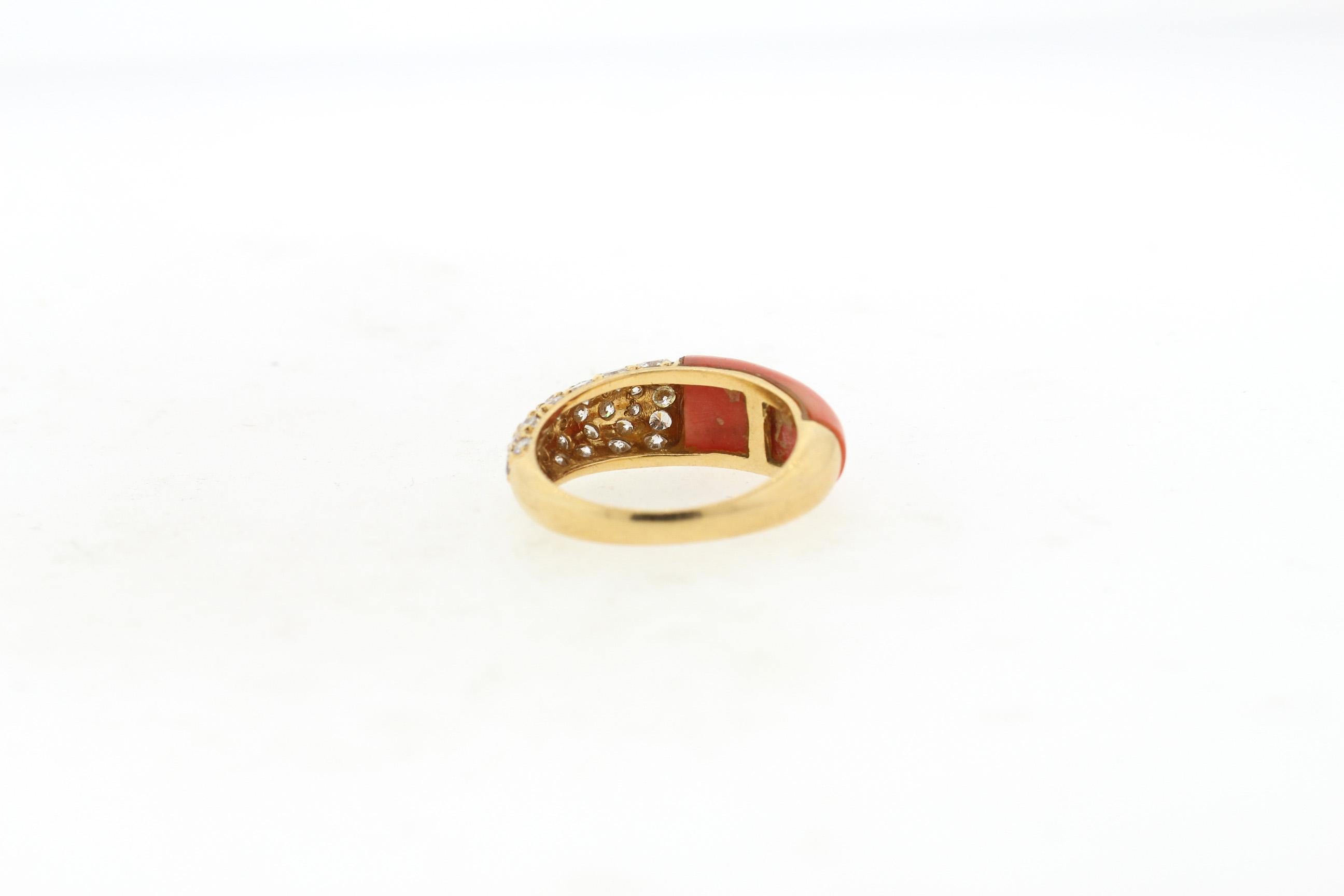Vintage 18k gold coral and diamond ring by Cartier circa 1970. The coral and the diamonds oppose each other on the finger. One side is set with 30 modern round brilliant diamonds weighing about 1.10 cts total. The ring is slightly domed and would