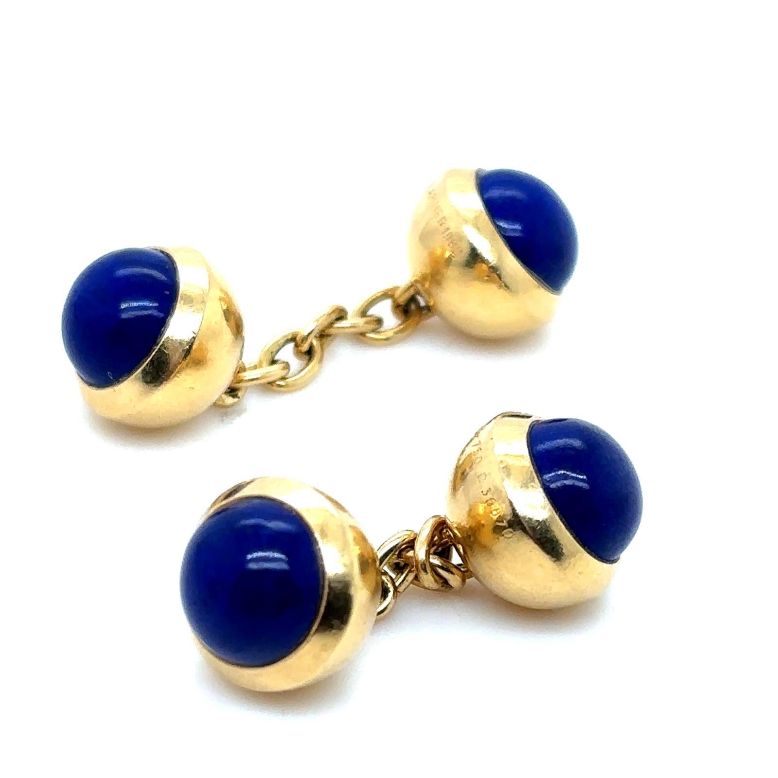 A pair of vintage Cartier 18 karat yellow gold lapis lazuli chain link cufflinks, 1990

Designed as a pair of gold balls each set with a domed rich blue cabochon cut lapis lazuli to either end.

The solid and secure plain polished chain link