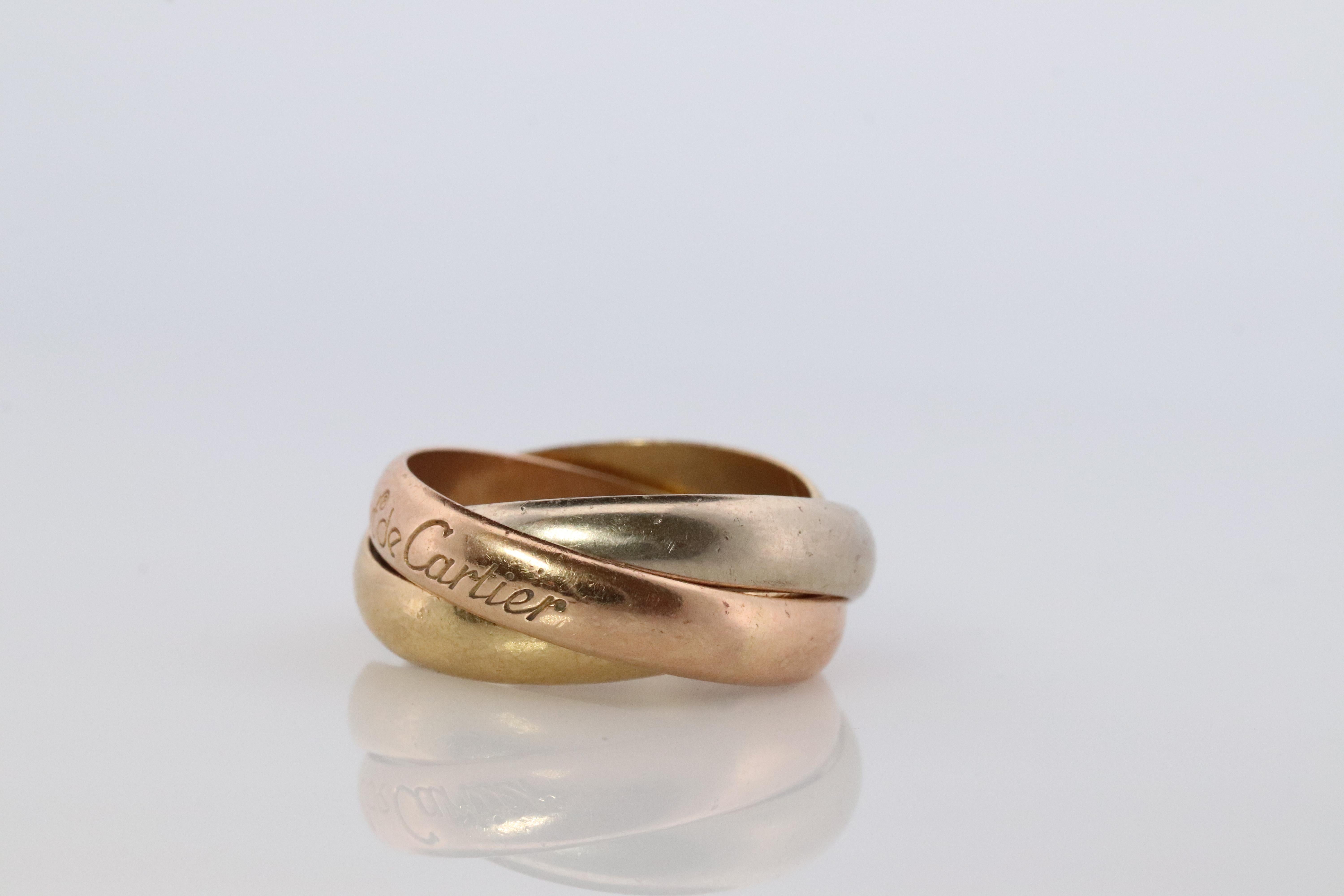 Beautiful Rolling 18k Tri band ring. Hallmarked and tests 18k. 

Cartier made 80s
Rose, White and Yellow gold.
Condition: Has tiny scratches. Nothing major.
Details:
6.9grams total

Size 5 or 49

Each band is 3.5mm wide