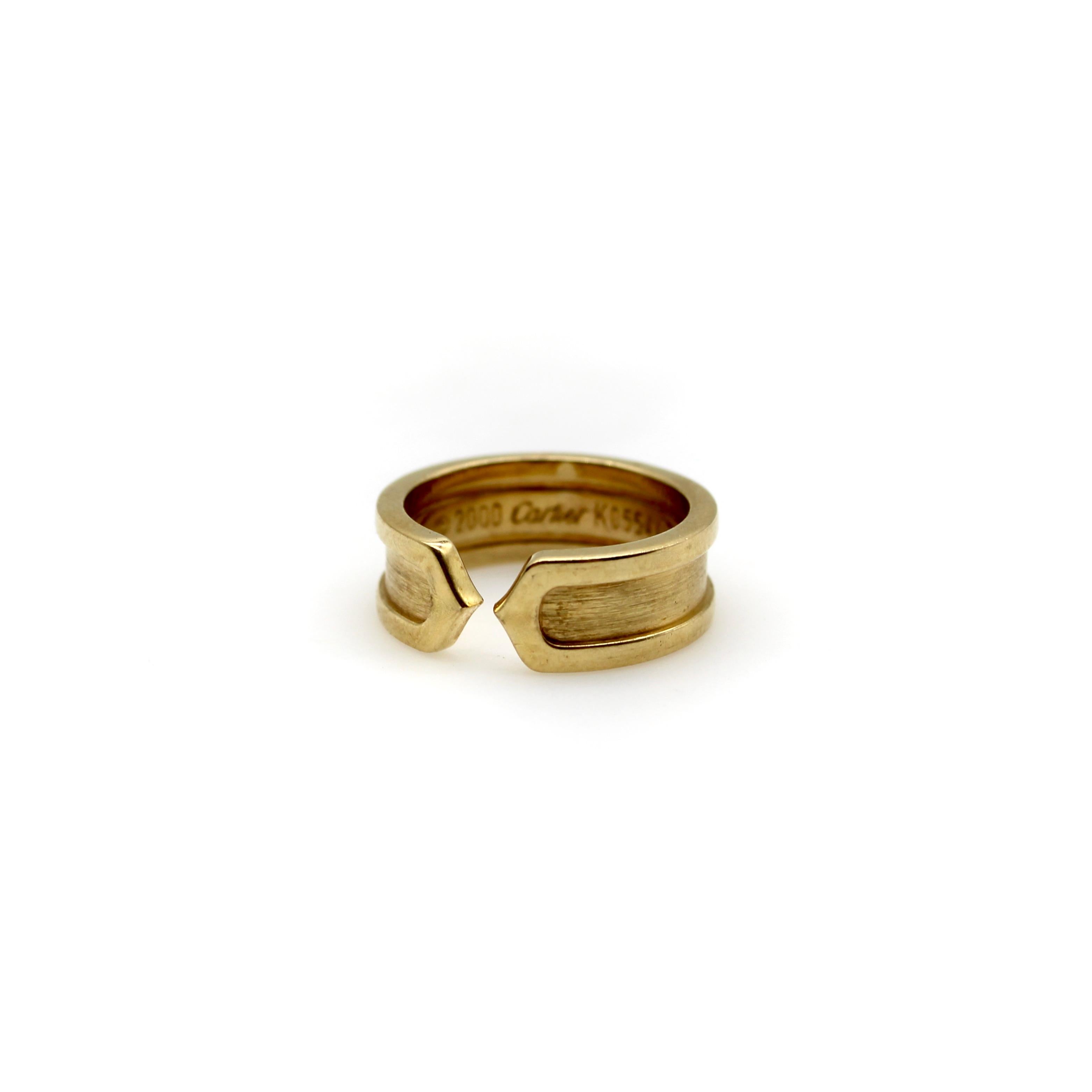This 18k gold ring is a play on the classic double-c Cartier design. An abstracted c raises up as an exterior border that continues around the band. Two c’s back up against each other, meeting at a sharp point in the middle of the ring for a clean,