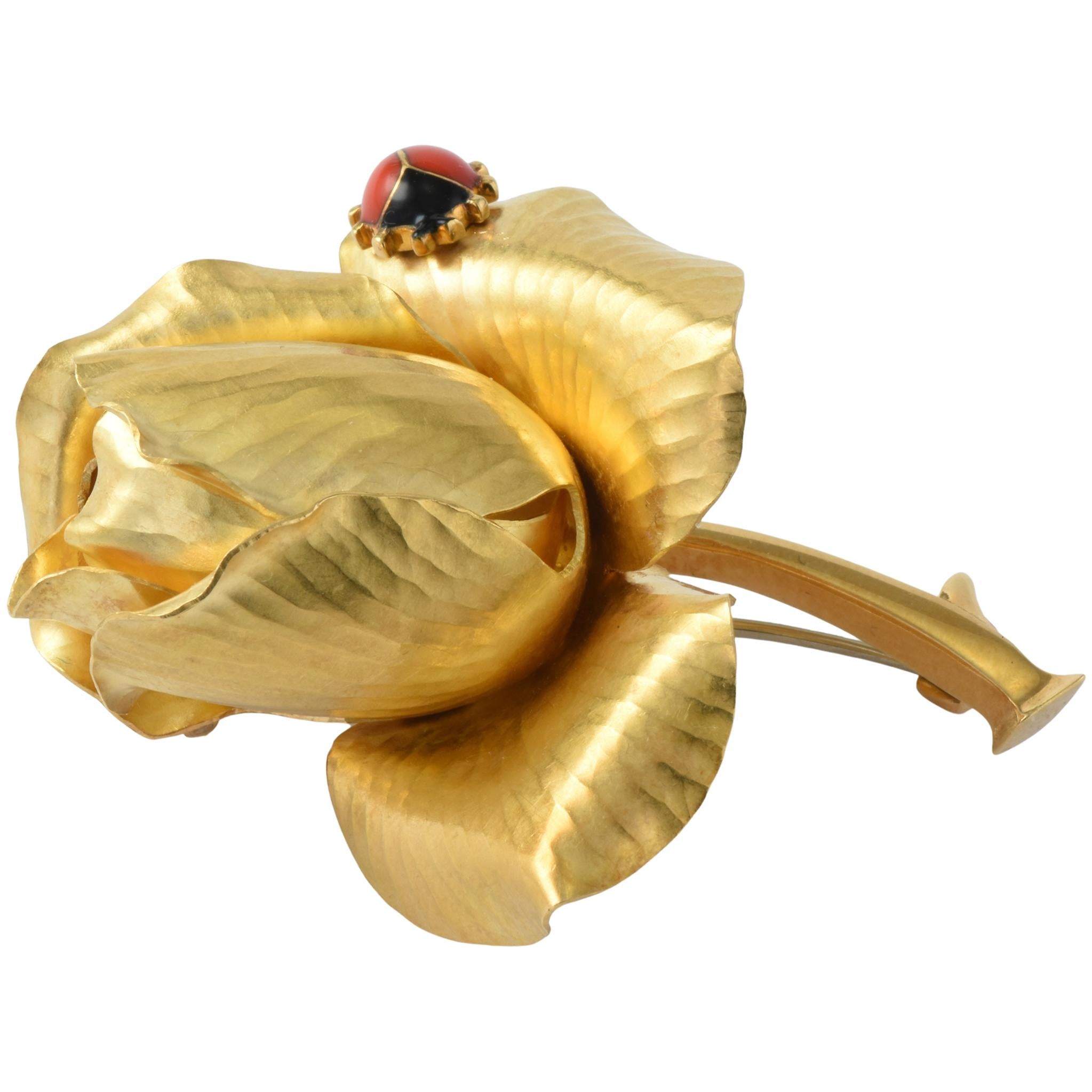 A wonderful vintage flower brooch by Cartier.

 

Modelled in 18k brushed finish gold, realistically designed as a rose adorned with an enamel ladybug.

 

Signed and numbered with makers mark and U.K import marks for London 1963