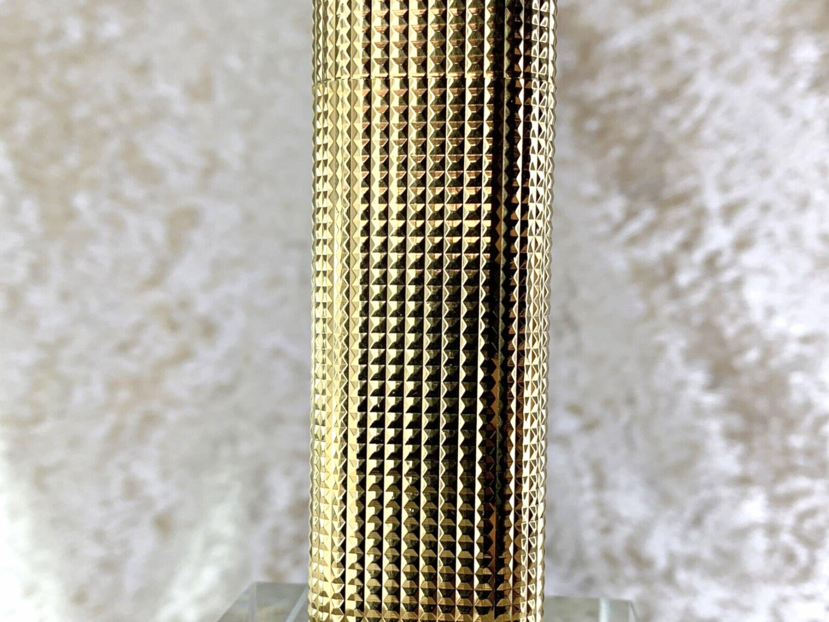 Vintage Cartier Lighter 18K Gold Plated 
Pyramid Cut Texture Model
Excellent working condition 
70 x 25 x 12 mm
Circa 1980s
Comes with original Cartier case 
With original Cartier certificate 
Original papers
The lighter ignites, sparks and flames 