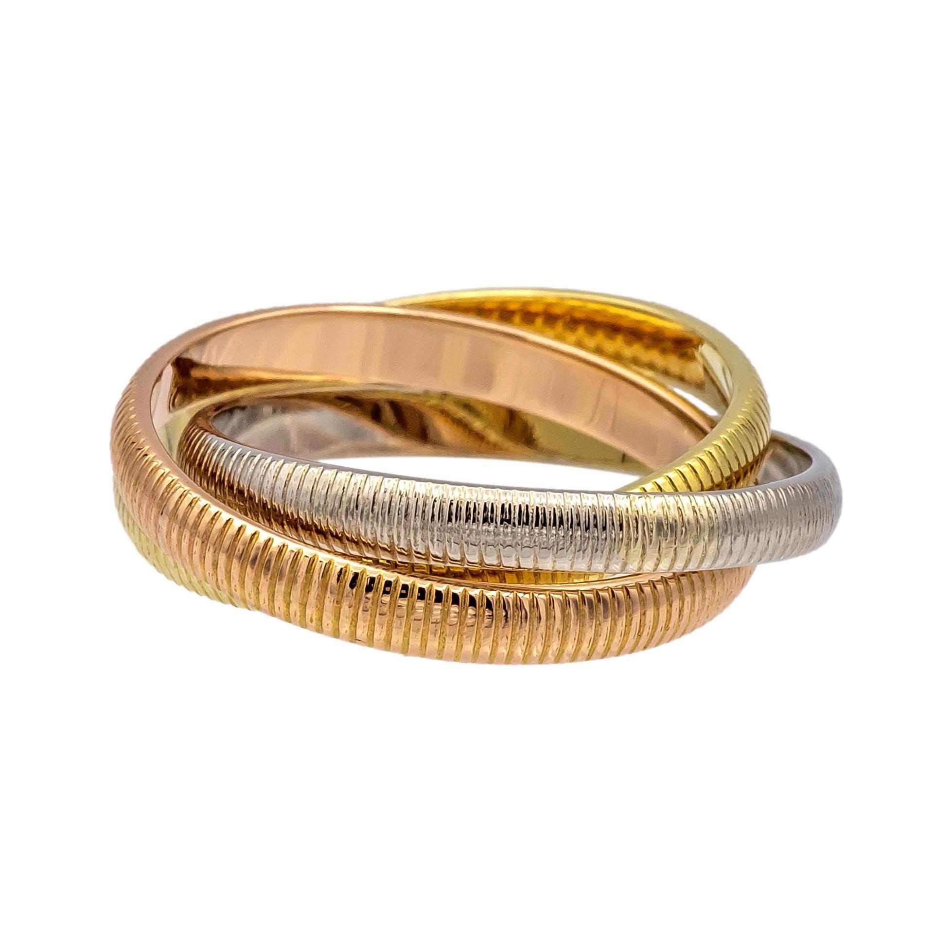 This vintage Cartier Trinity Ring features the iconic interlocking three-band design in 18K yellow, white, and rose gold, with a ribbed texture that enhances its distinct style. The hallmarks are fully intact, and the ribbed texture shows minimal