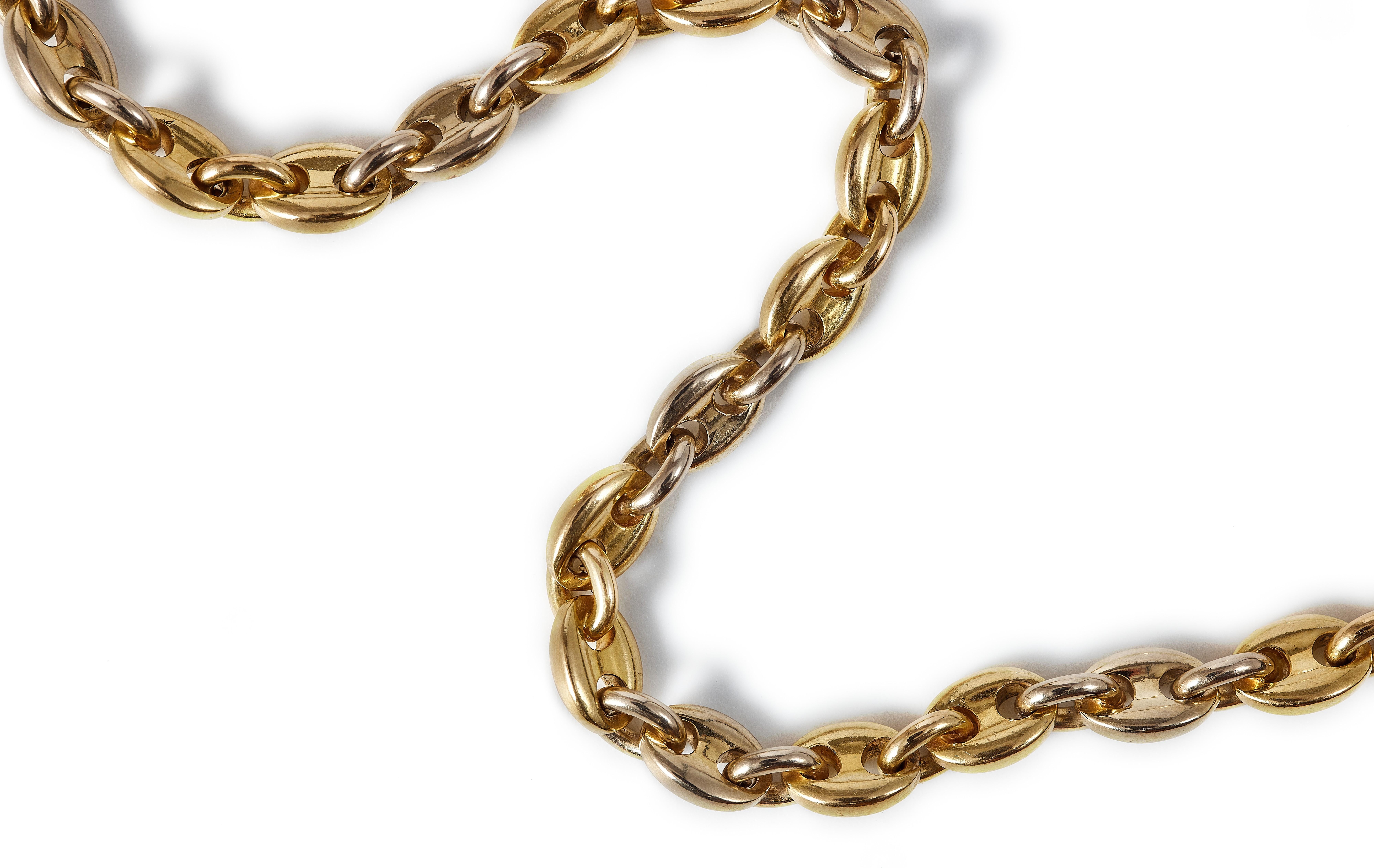 Vintage Cartier, a super versatile. 18K gold bi-color necklace. Designed as a series of gold mariner and oval links, alternating between two yellow and one white link.  Small yet solid links, this chain is the perfect mix of hefty and delicate.