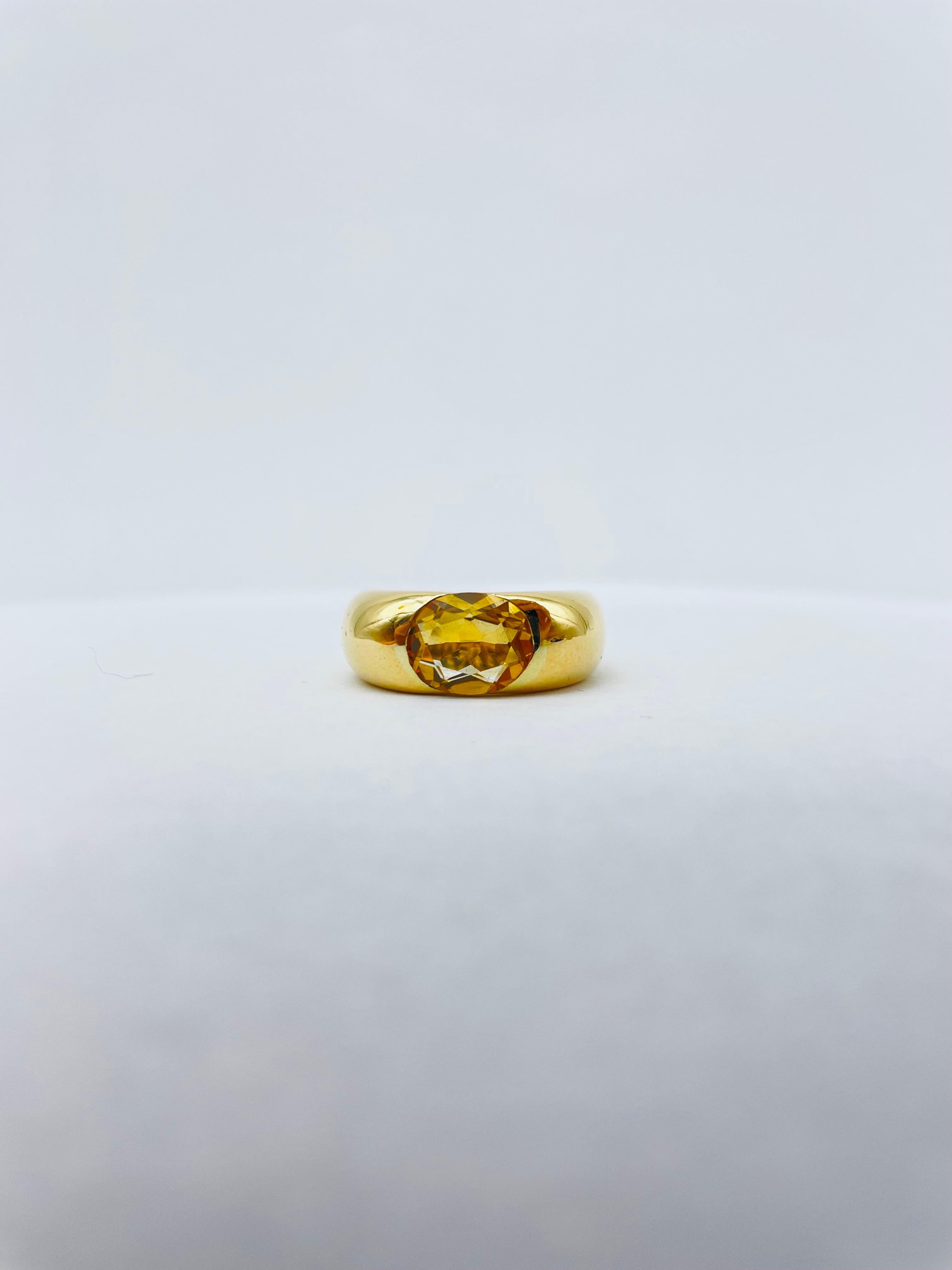 Behold the majestic Vintage Cartier 18K Ring, a true masterpiece that captures the essence of luxury and timeless elegance. This Big Ellipse Citrine Band Ring by Cartier from 1993 is a rare and sought-after treasure that will leave you