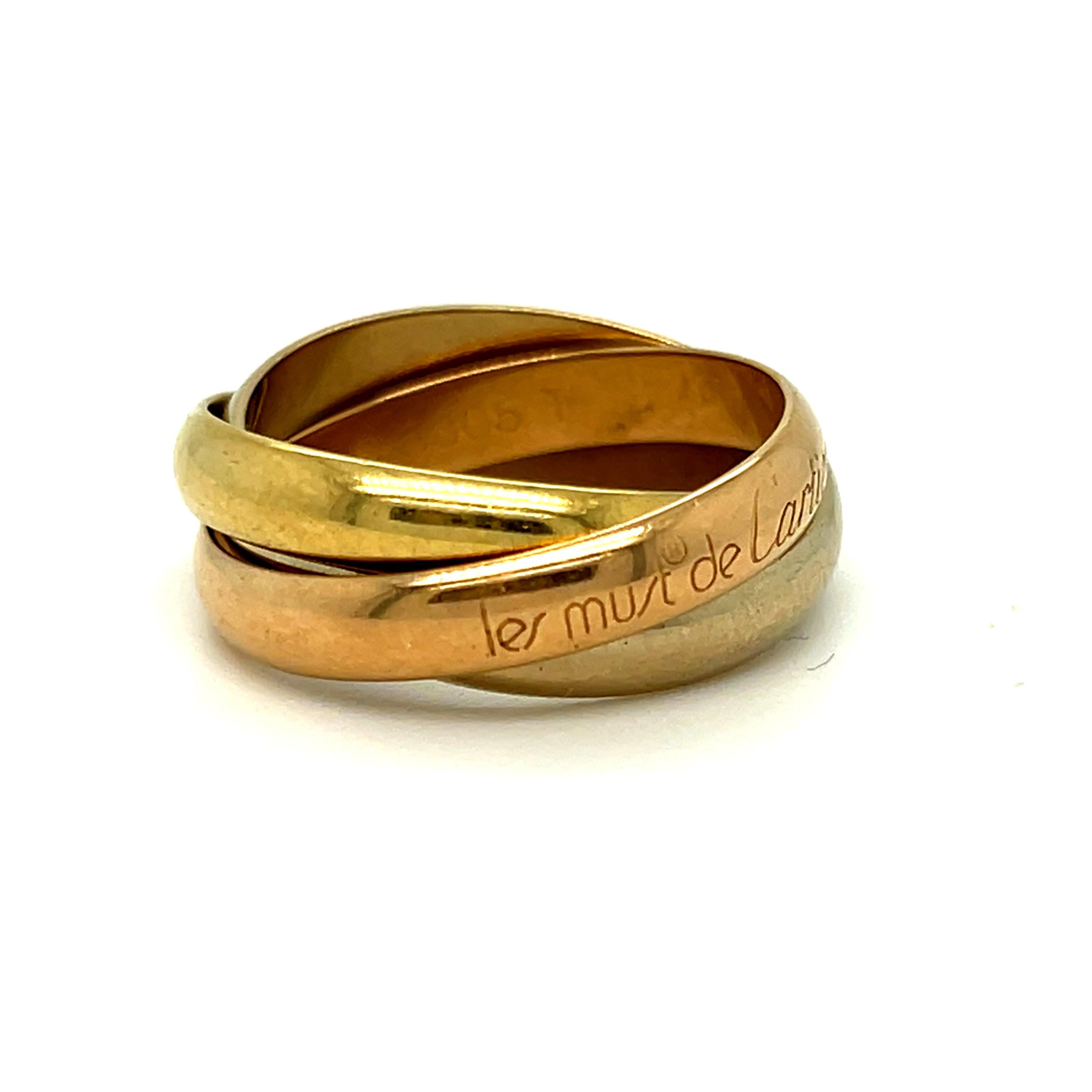 Simple, Classic, Cartier, and Beautiful -  this Vintage Tri Colored Gold Ring Wedding Band is a classic that's never gone out of style! Crafted in 18K Rose, White and Yellow Gold, the band features Three Bands of the different colors all locked