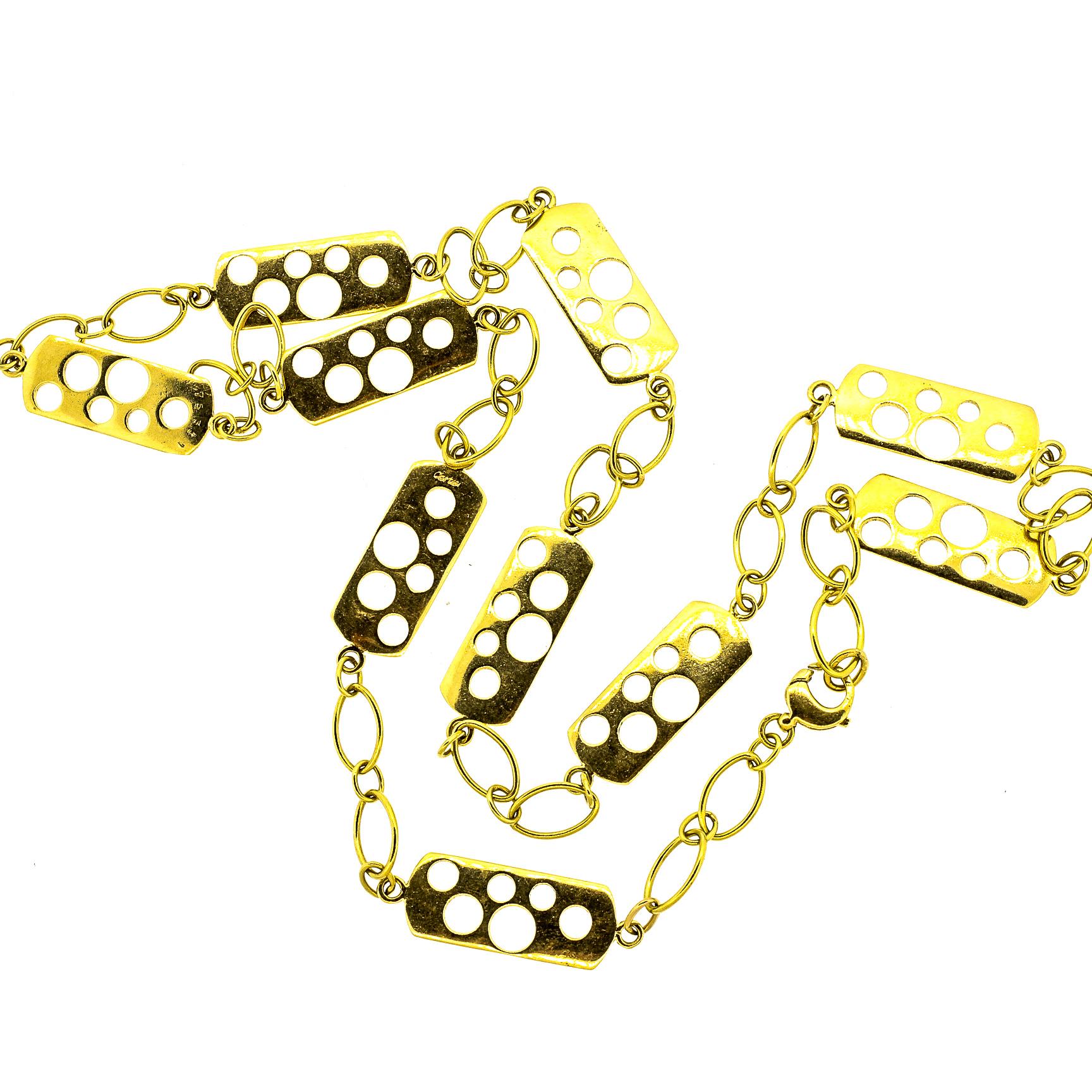 Unusual vintage Cartier 18k yellow gold fancy link necklace from the 1970s. This chain has panels of gold with cut out circles of different sizes and large loop links in between. The chain is light looking though it is hefty, and has nice dimension.
