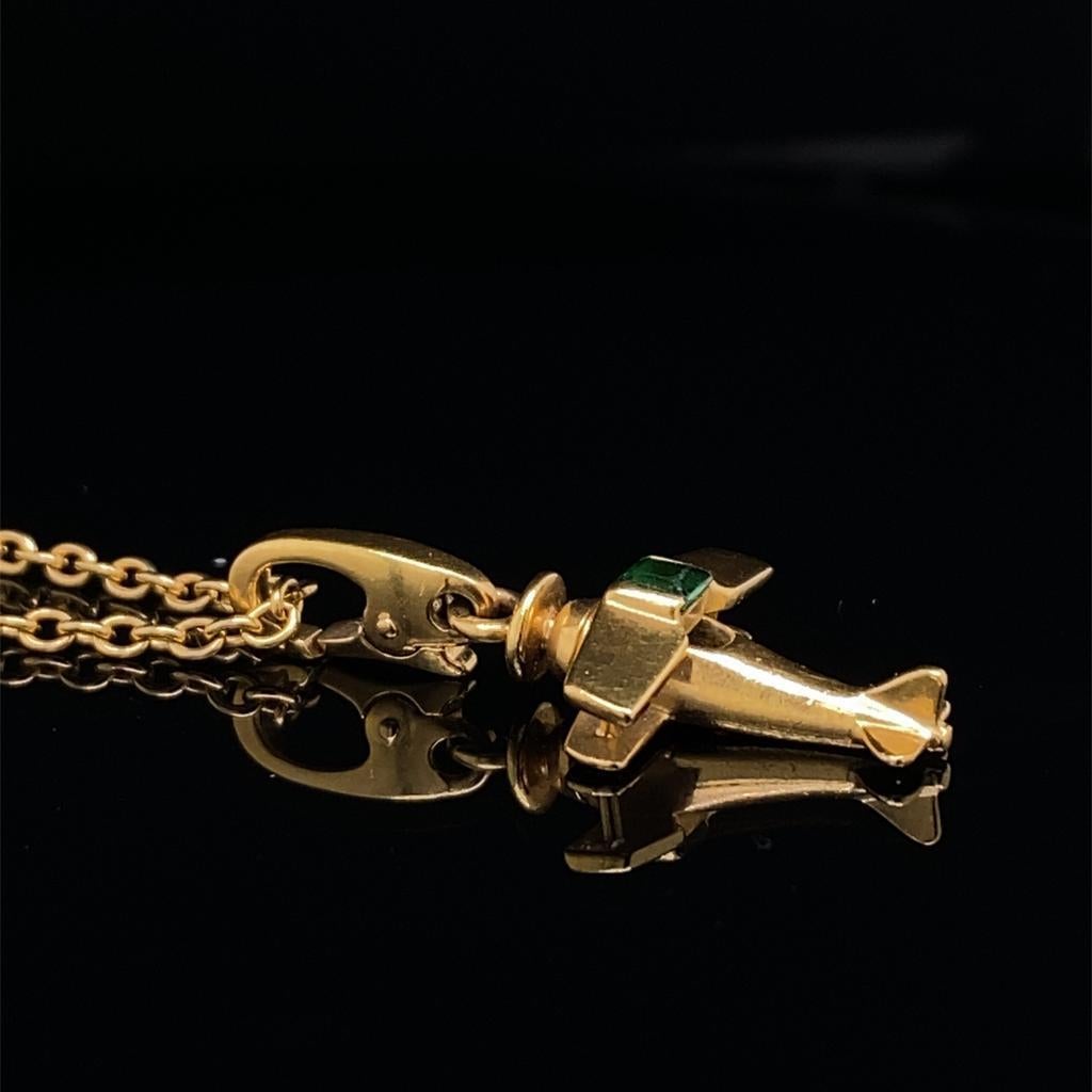 A Vintage Cartier airplane emerald set charm in 18 karat yellow gold, circa 1990's

This charm is a fun piece from Cartier, set to its centre with a rich green cabochon emerald. Together with a flat link chain also of 18 karat yellow gold, not by