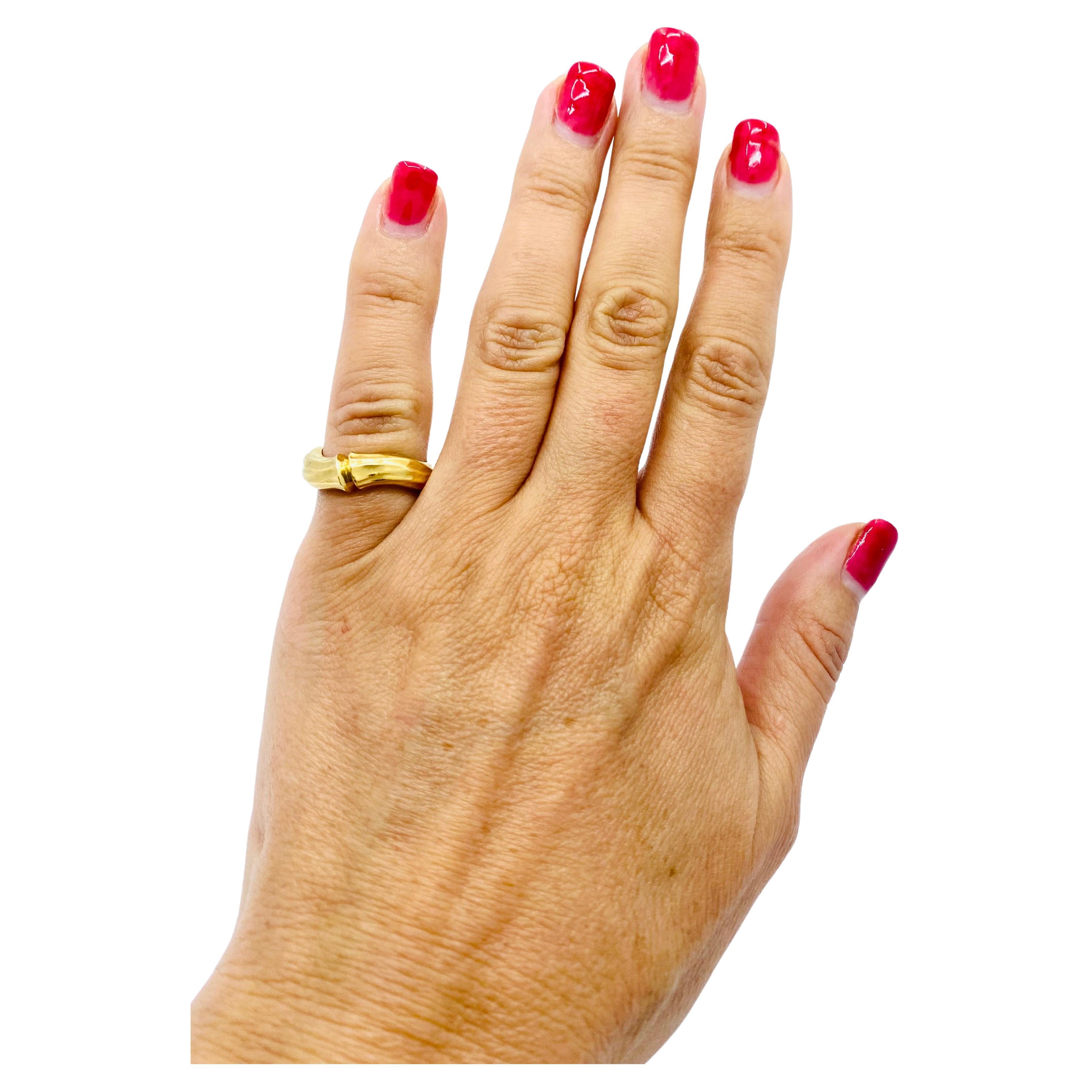 DESIGNER: Cartier
CIRCA: 1970s
MATERIALS: 18k Yellow Gold
WEIGHT: 7.2 grams
RING SIZE: 5.75-6
HALLMARKS: Cartier, 750, 678 444

A vintage ring by Cartier from Bamboo collection made of 18k gold.
The Cartier Bamboo collection is a line of jewelry and