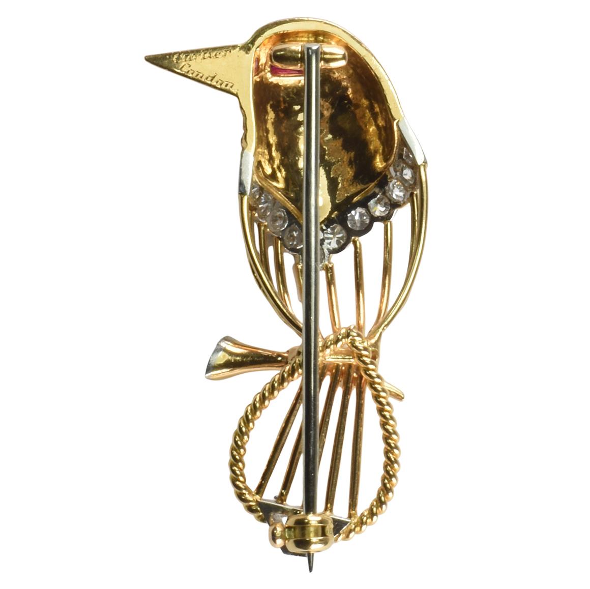 An adorable superbly modelled bird brooch by renowned  jewellery house Cartier. Crafted from 18ct Gold with rope twist and textured detailing and platinum settings. Set with a step cut ruby eye. Brilliant cut diamonds and a trapezoid cut diamond.