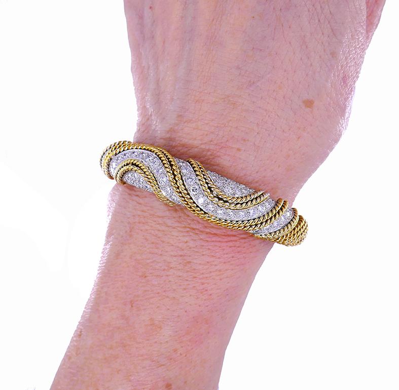 A stunning Cartier bracelet made of 18k braided gold and diamond.
The bracelet is meticulously crafted out of twisted gold wires. They are weaved and wrapped around to shape the “body” of the bracelet. Wavy wires on the front of the bracelet, along