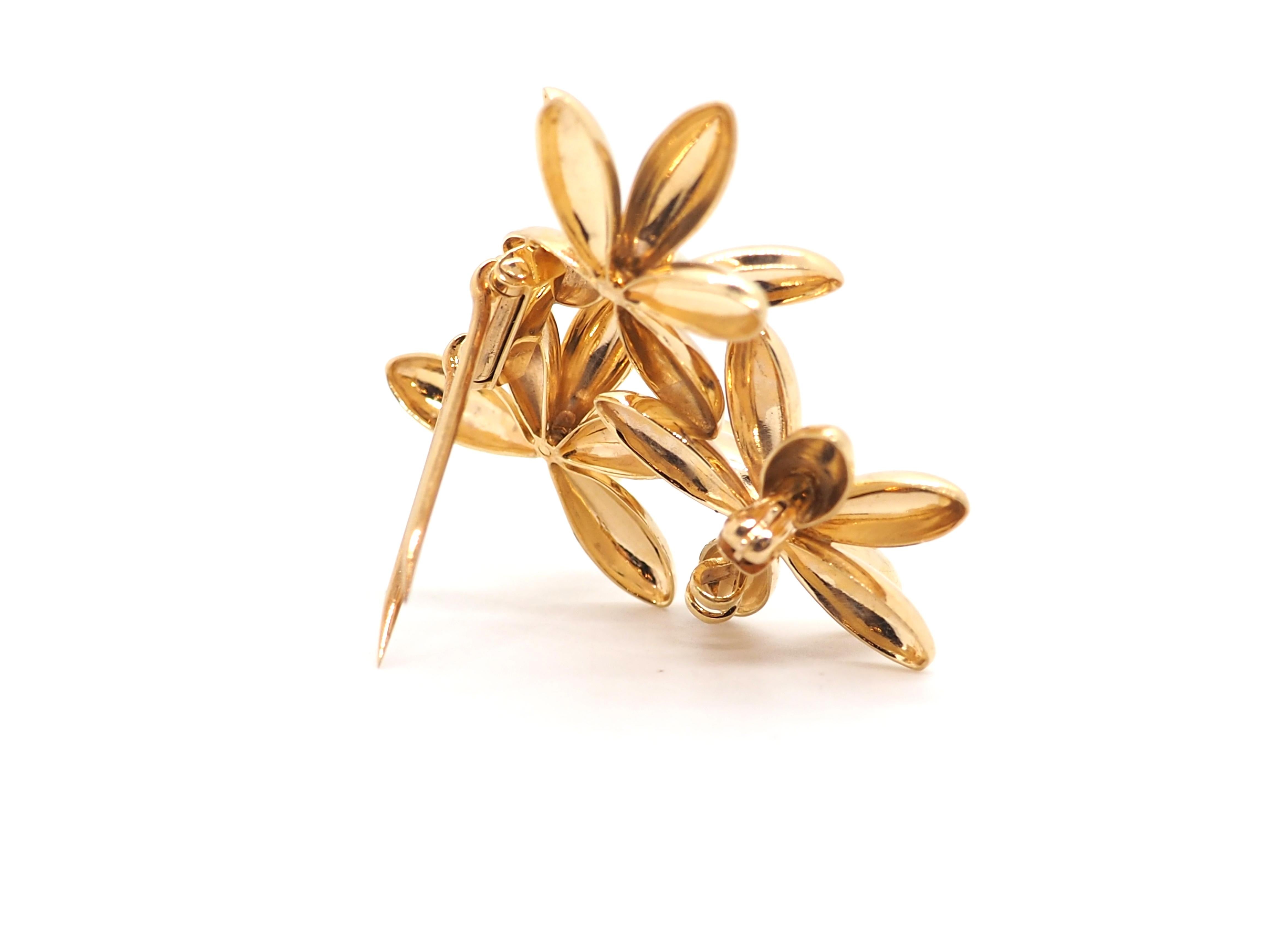 Rare Vintage Cartier 14k Yellow Gold Brooch with Exquisite 3-Flower Design. Step into a world of opulence and elegance with our extraordinary Vintage Cartier Brooch.

With its intricate detailing and impeccable craftsmanship, this brooch is a true
