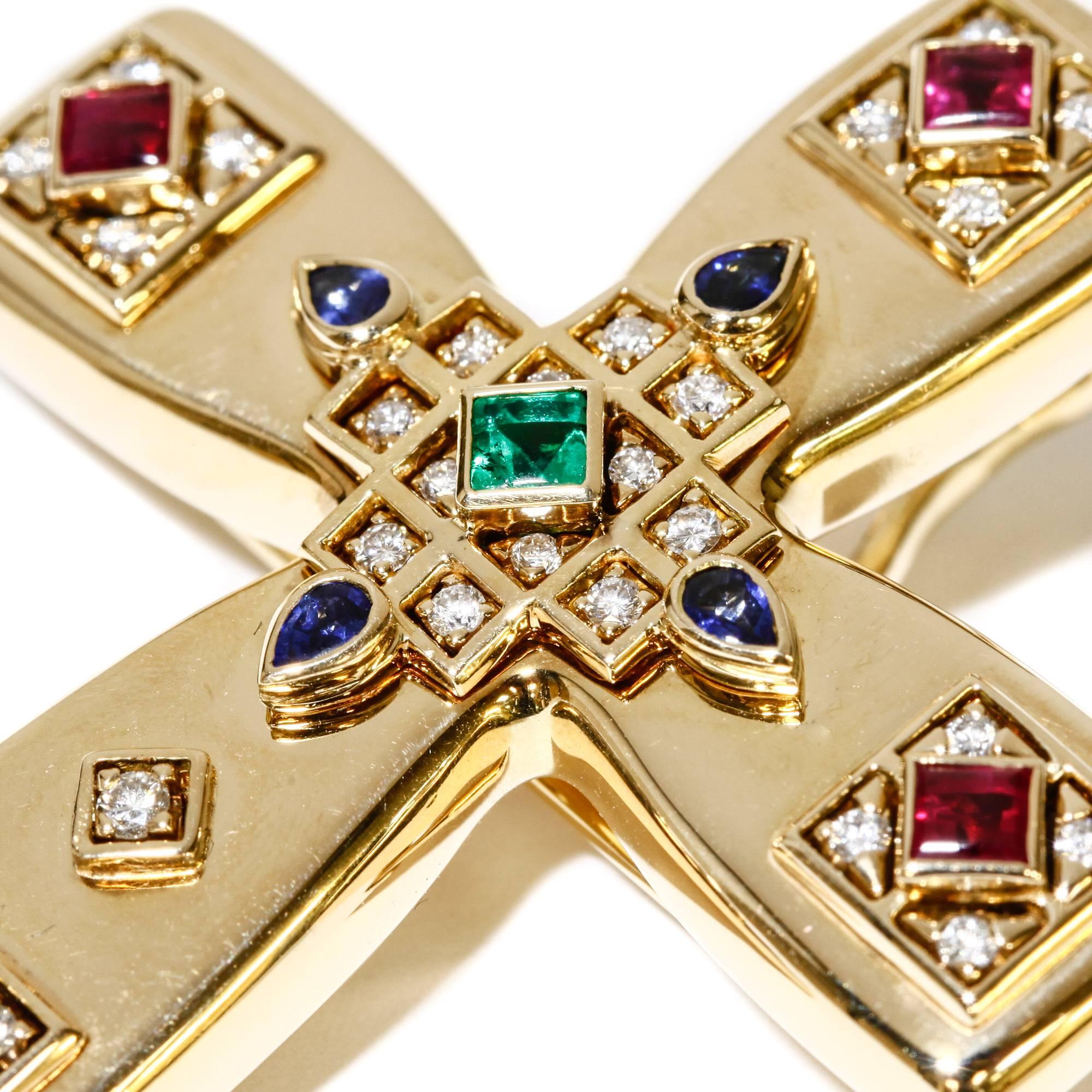 This Vintage Cartier Byzantine gem-set cross is in excellent condition. 

-- Solid 18k yellow gold set with colorless round diamonds, pear-shaped sapphires, square rubies and a square emerald
-- Can be worn as a pin or pendant
-- Made in 1993 (date