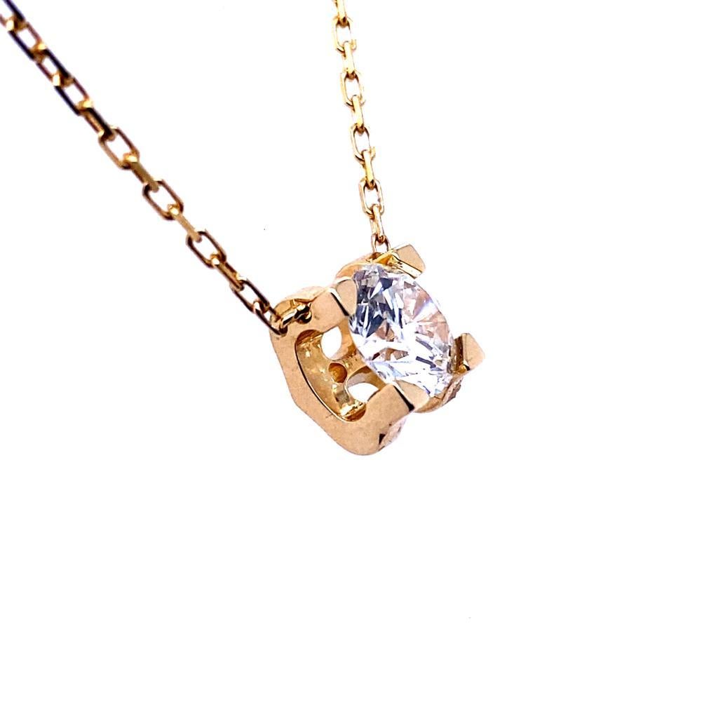 A vintage Cartier ‘C de Cartier’ diamond pendant and chain 18 karat yellow gold, circa 2000.

This elegant pendant is designed as a single round brilliant cut diamond tension set within the  signature Cartier double C’s; joined together to form