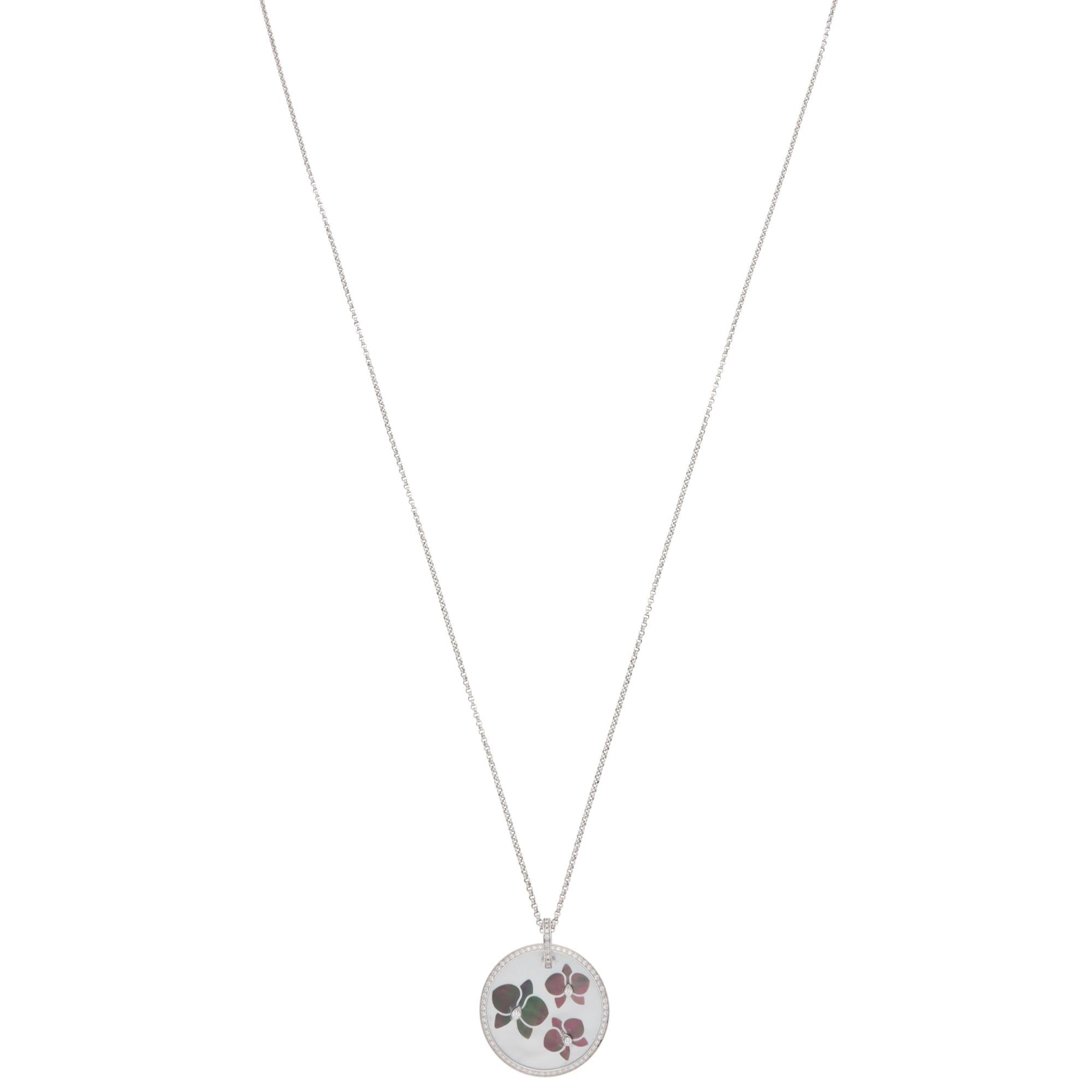 A classic vintage Cartier Caresse d'Orchidées mother-of-pearl and diamond pendant necklace set in 18k white gold.

From the Caresse d'Orchidées collection, the pendant is set with grey and white mother-of-pearl plaques in orchid motifs. There are 75