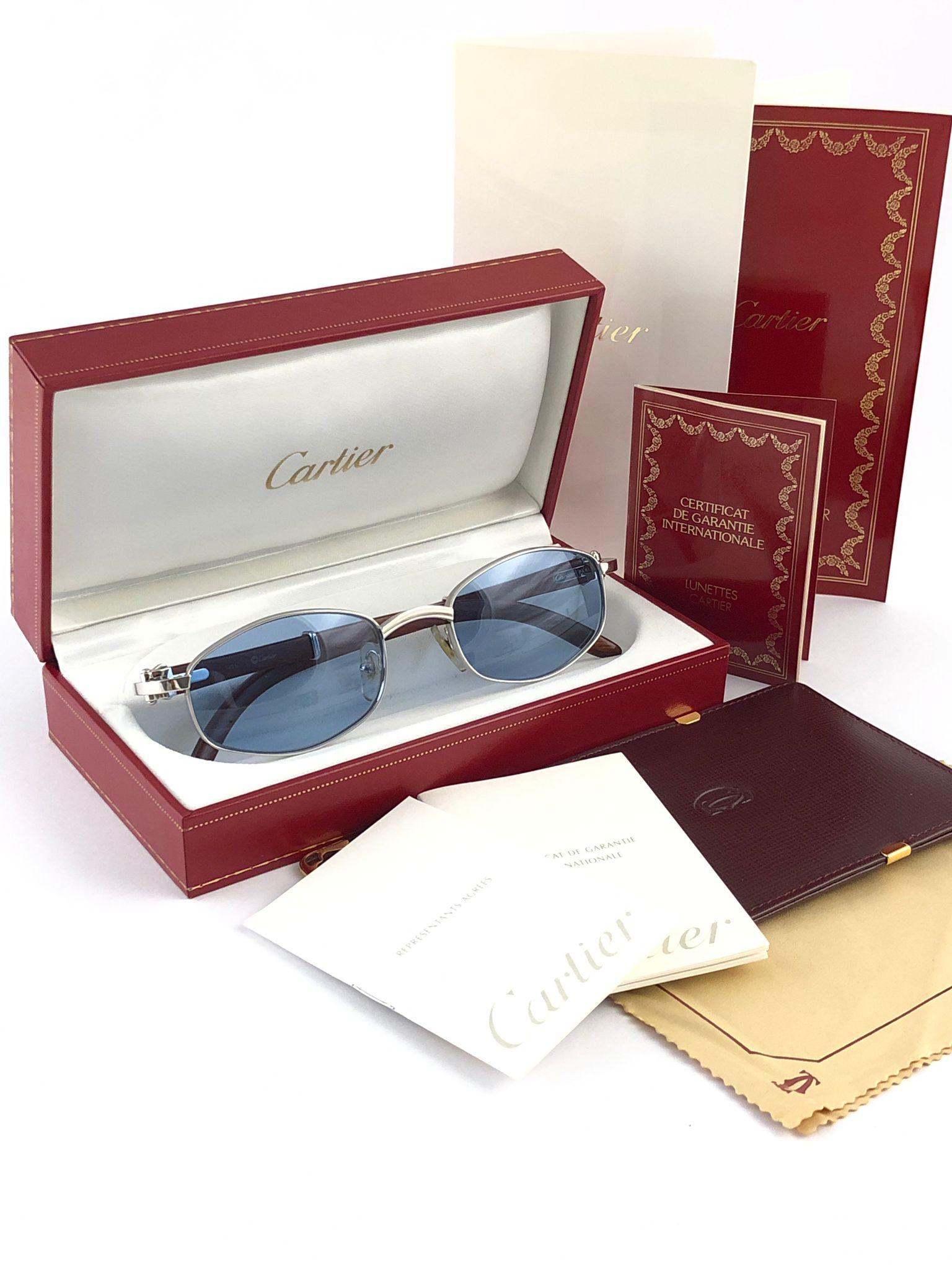 New 1990 Cartier Full Set Cartayat Hardwood Sunglasses with new light blue  (uv protection) lenses. 
Frame is with the front and sides in white gold and has the famous wood & gold accents temples. 
Amazing craftsmanship! All hallmarks. Both arms