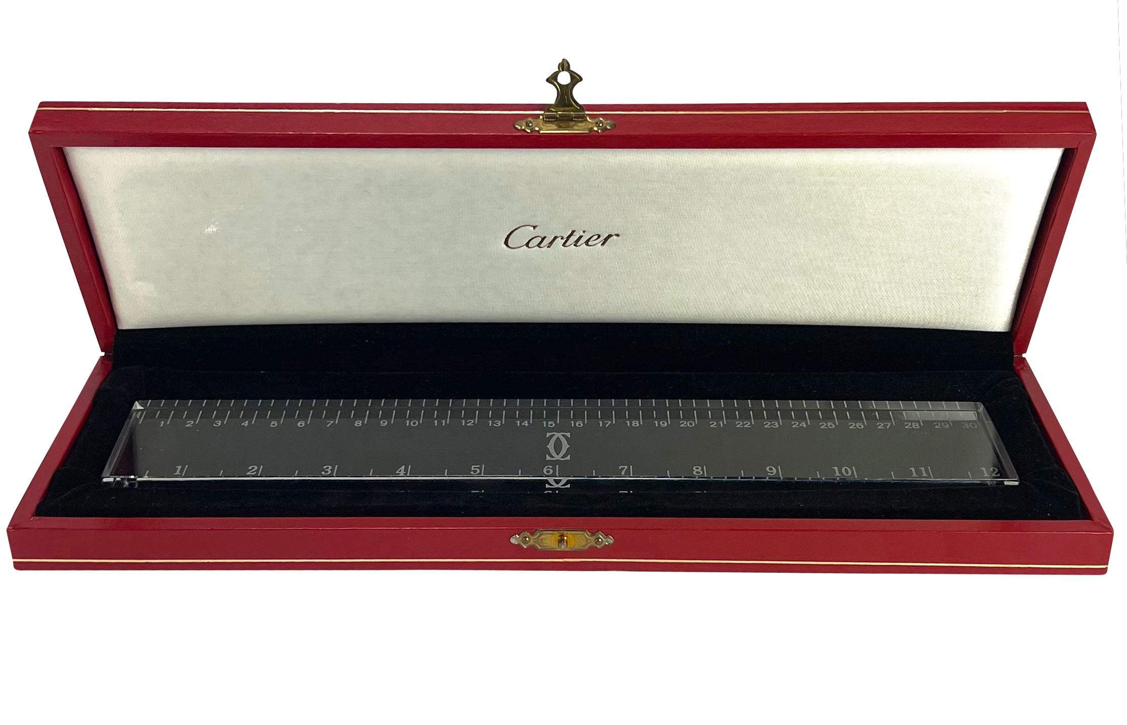 TheRealList presents: a fabulous crystal Cartier ruler paperweight. The perfect addition to any desk, this piece is perfect for taking measurements or weighing down papers. Made complete with the original presentation box, this paperweight is a