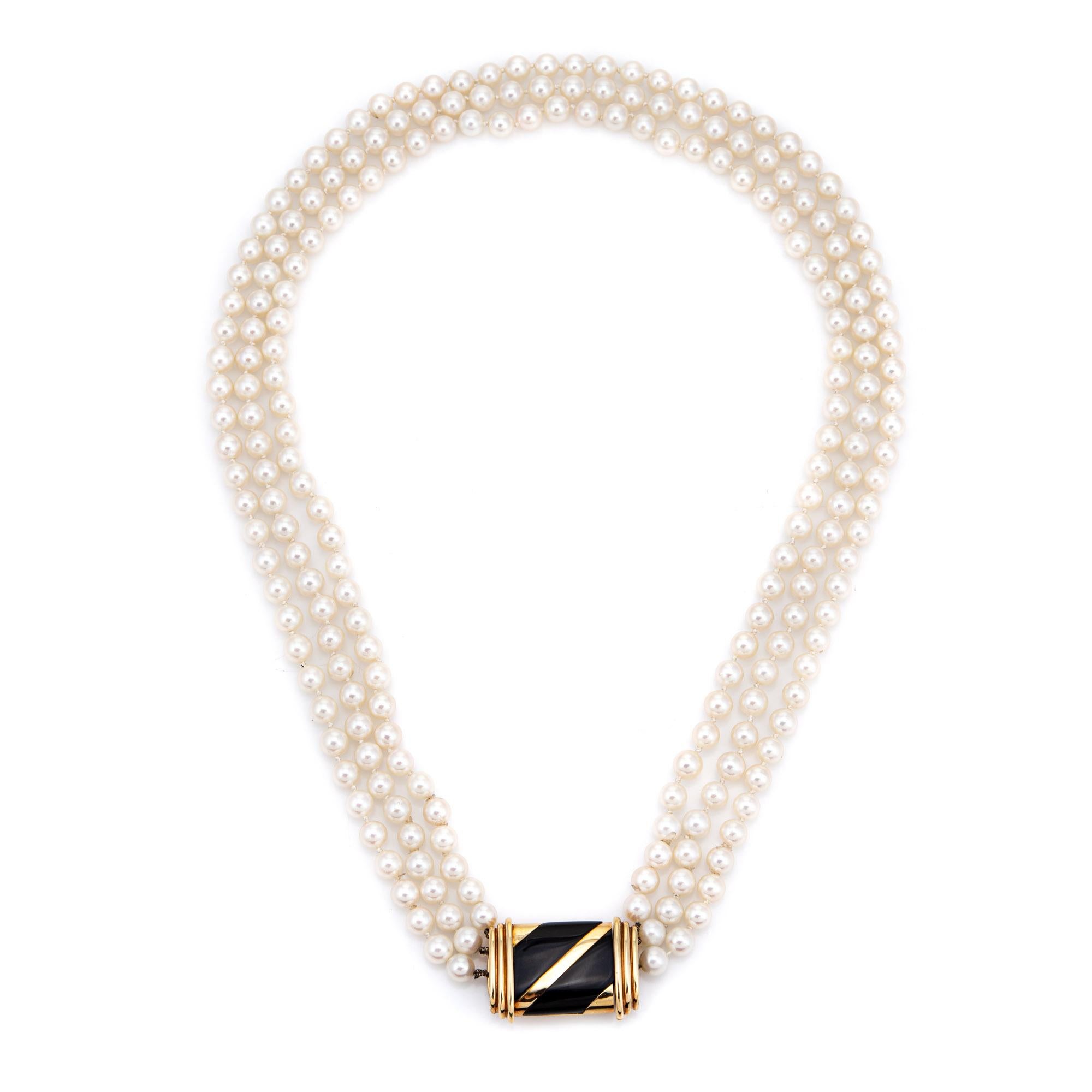 Stylish vintage Cartier triple stand cultured pearl necklace (circa 1960s to 1970s) finished with an 18k gold onyx inlaid clasp.  

Cultured pearls are uniform in size and measure 6mm, strung onto three strands. The pearls are lustrous with a thick