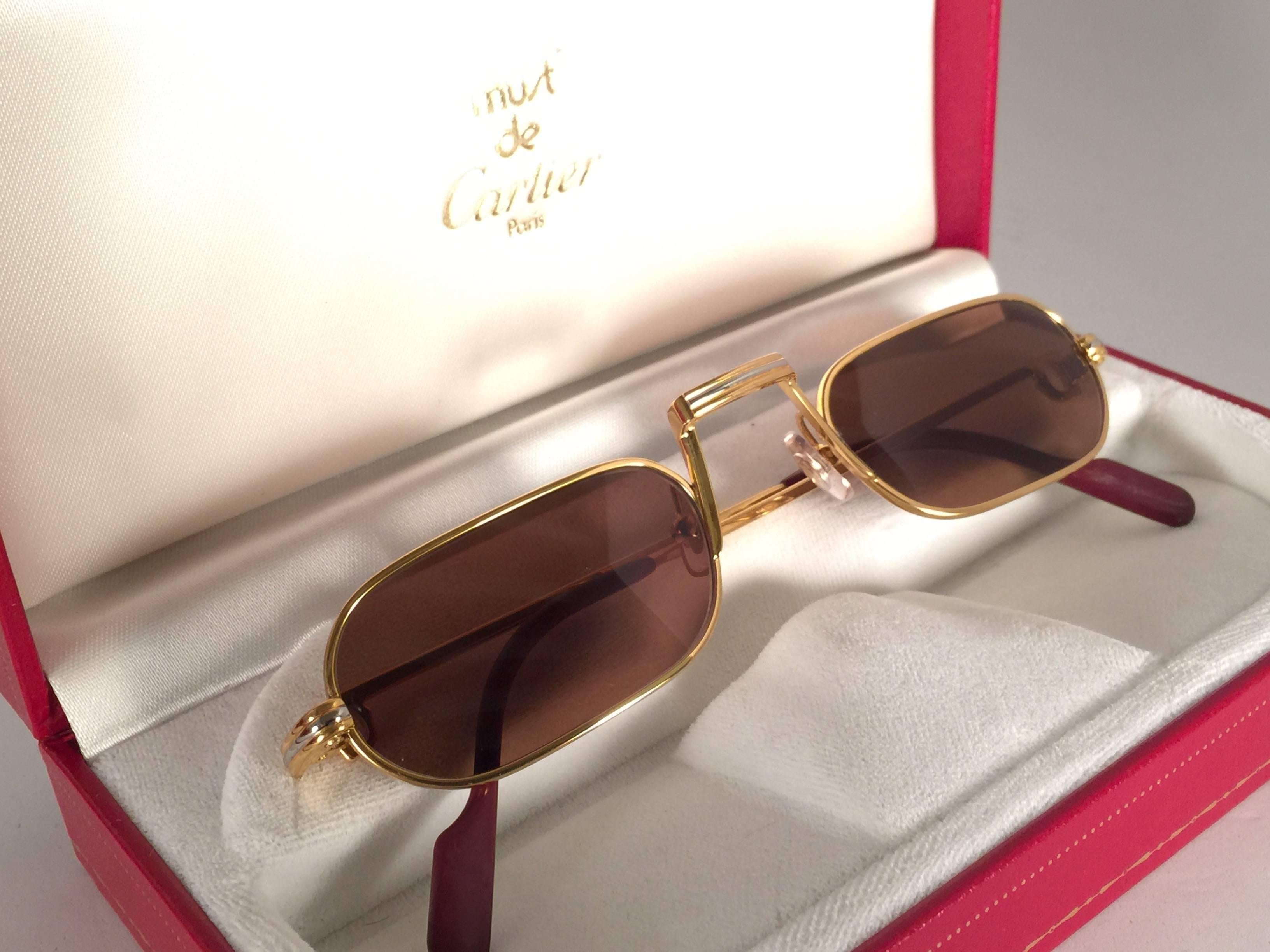 Original 1983 Cartier Demilune Cartier Vendome sunglasses with new honey brown lenses. Very comfortable as reading glasses. All hallmarks. Red enamel with Cartier gold signs on the burgundy ear paddles. Both arms sport the C from Cartier on the