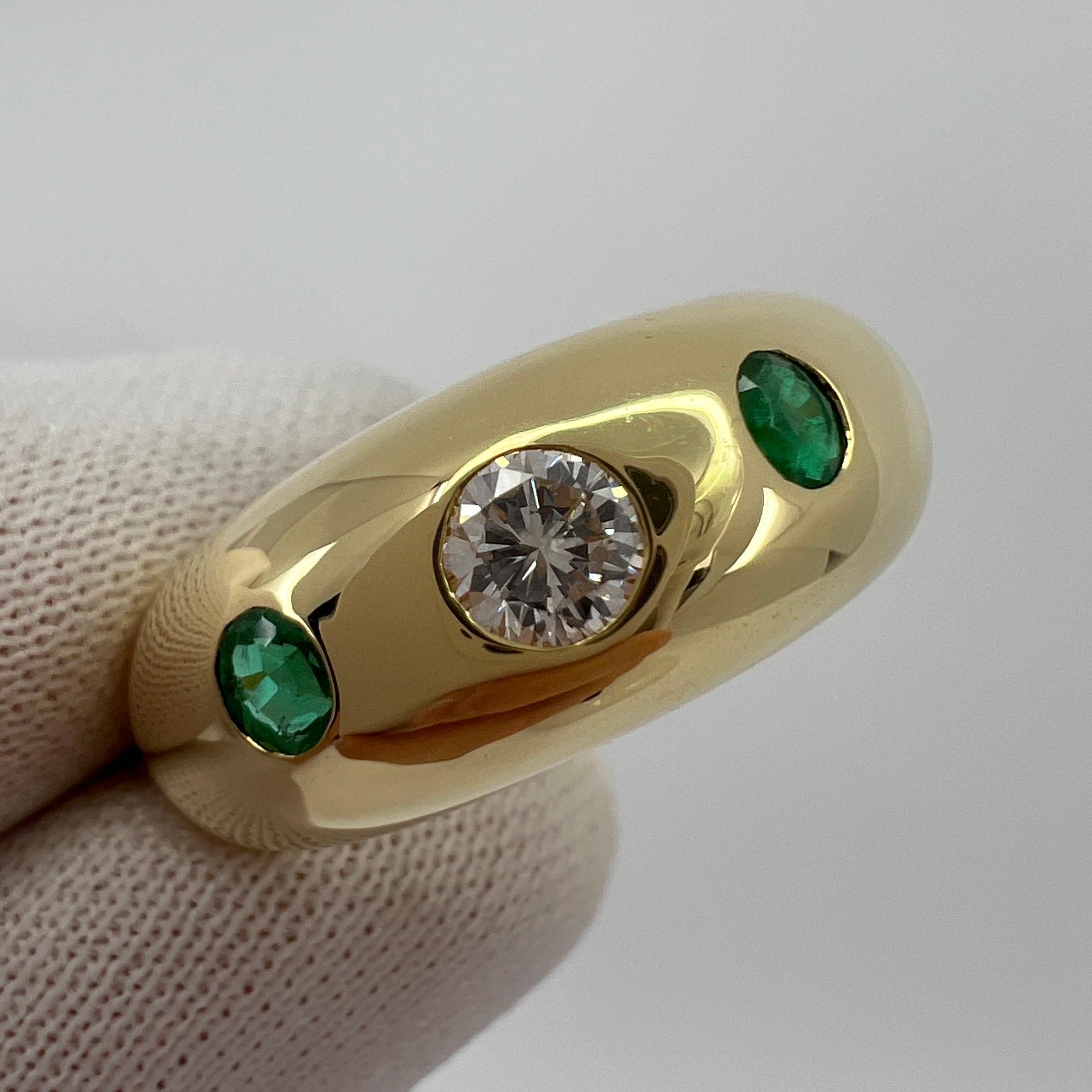Vintage Cartier Diamond And Emerald 18k Yellow Gold Three Stone Dome Ring.

Stunning yellow gold Cartier ring set with a beautiful 3.5mm centre diamond with F/G Colour and VVS clarity. This is accented by 2 fine green emeralds approx 2.5mm
